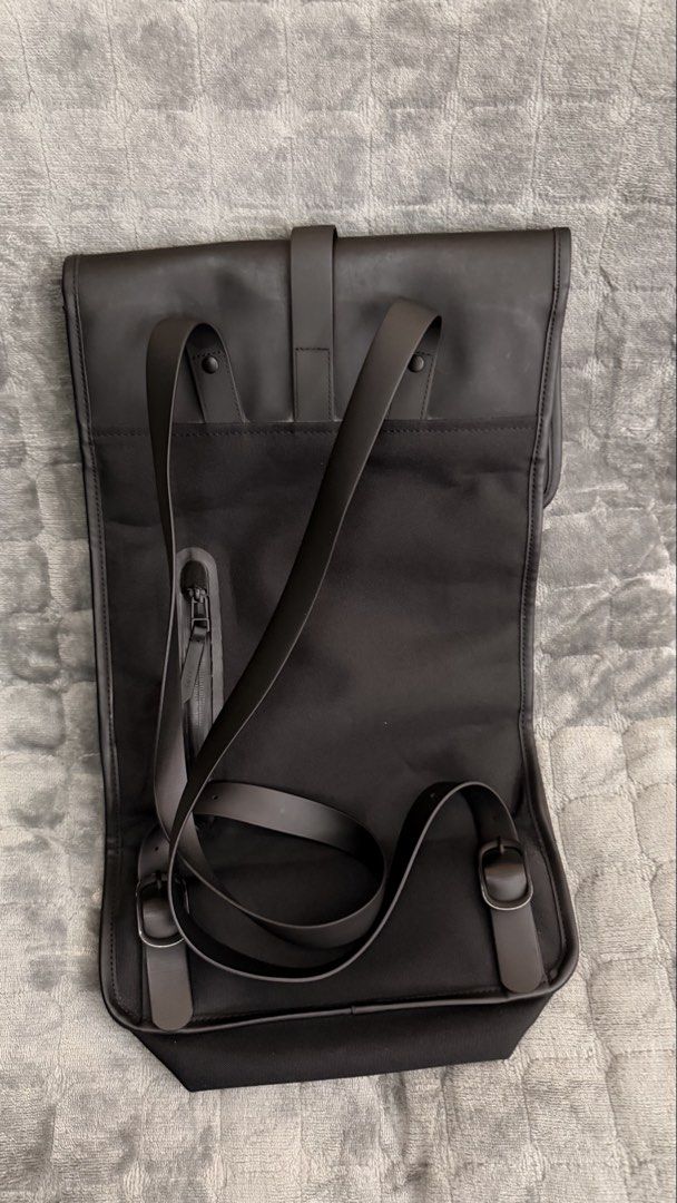 Rains Backpack (Category: Backpacks) located in Alfonso. Submitted by jbcamet (Listing ID 1423818653, Image 2). Description: - Black Rains backpack - Main compartment with zipper - Interior pocket - Front flap with strap closure - Adjustable shoulder straps - Waterproof design - Rains logo inside.