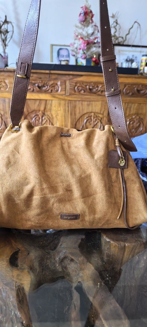 Songmont Suede Shoulder Bag (Category: Luxury Bags & Wallets) located in Cagayan de Oro. Submitted by tommygurl1218 (Listing ID 1423846221, Image 1). Description: - Songmont shoulder bag - Suede exterior - Brown leather straps - Spacious interior - Stylish design - Includes brand tag - Comfortable shoulder strap - Beautiful brown color.