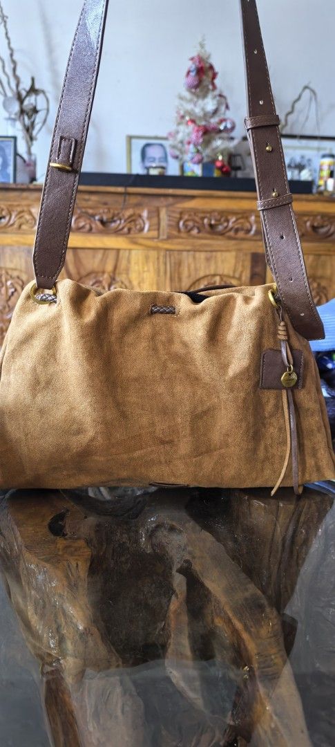 Songmont Suede Shoulder Bag (Category: Luxury Bags & Wallets) located in Cagayan de Oro. Submitted by tommygurl1218 (Listing ID 1423846221, Image 2). Description: - Songmont shoulder bag - Suede exterior - Brown leather straps - Spacious interior - Stylish design - Includes brand tag - Comfortable shoulder strap - Beautiful brown color.