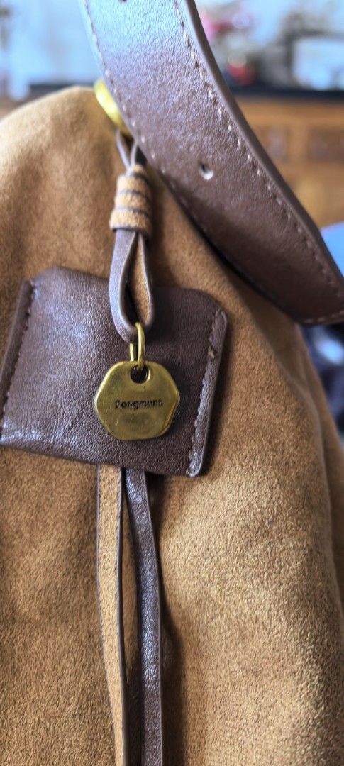 Songmont Suede Shoulder Bag (Category: Luxury Bags & Wallets) located in Cagayan de Oro. Submitted by tommygurl1218 (Listing ID 1423846221, Image 3). Description: - Songmont shoulder bag - Suede exterior - Brown leather straps - Spacious interior - Stylish design - Includes brand tag - Comfortable shoulder strap - Beautiful brown color.