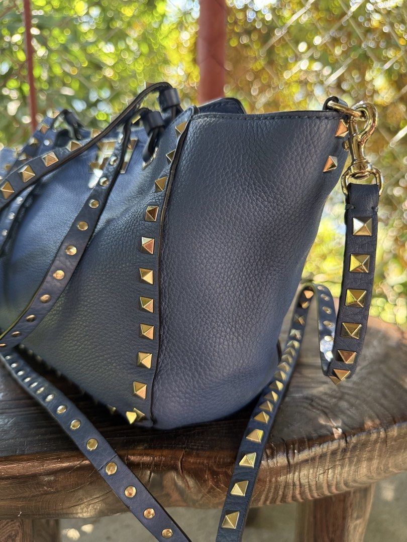 Valentino Garavani Rockstud Tote Bag (Category: Luxury Bags & Wallets) located in Manila. Submitted by fivethousandlilies (Listing ID 1423969070, Image 2). Description: - Valentino Garavani Rockstud tote bag - Gorgeous blue color - Gold-tone hardware - Iconic studded design - Top handle and detachable shoulder strap - Interior zippered pocket - Valentino Garavani logo visible - Made in Italy.