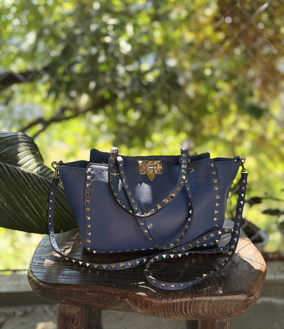 Valentino Garavani Rockstud Tote Bag (Category: Luxury Bags & Wallets) located in Manila. Submitted by fivethousandlilies (Listing ID 1423969070, Image 1). Description: - Valentino Garavani Rockstud tote bag - Gorgeous blue color - Gold-tone hardware - Iconic studded design - Top handle and detachable shoulder strap - Interior zippered pocket - Valentino Garavani logo visible - Made in Italy.