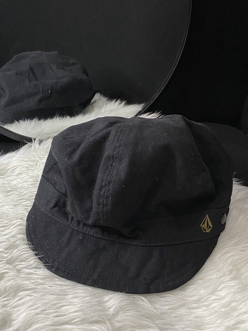 Volcom Cadet style cap (Category: Caps & Hats) located in Angeles City. Submitted by beracahstitchesxwears (Listing ID 1423896915, Image 1). Description: Based on the visual details and logo, this is a Volcom black hunting or cadet-style cap. The hat features a prominent gold-colored Volcom Stone logo embroidered on the side, a hallmark of the brand.