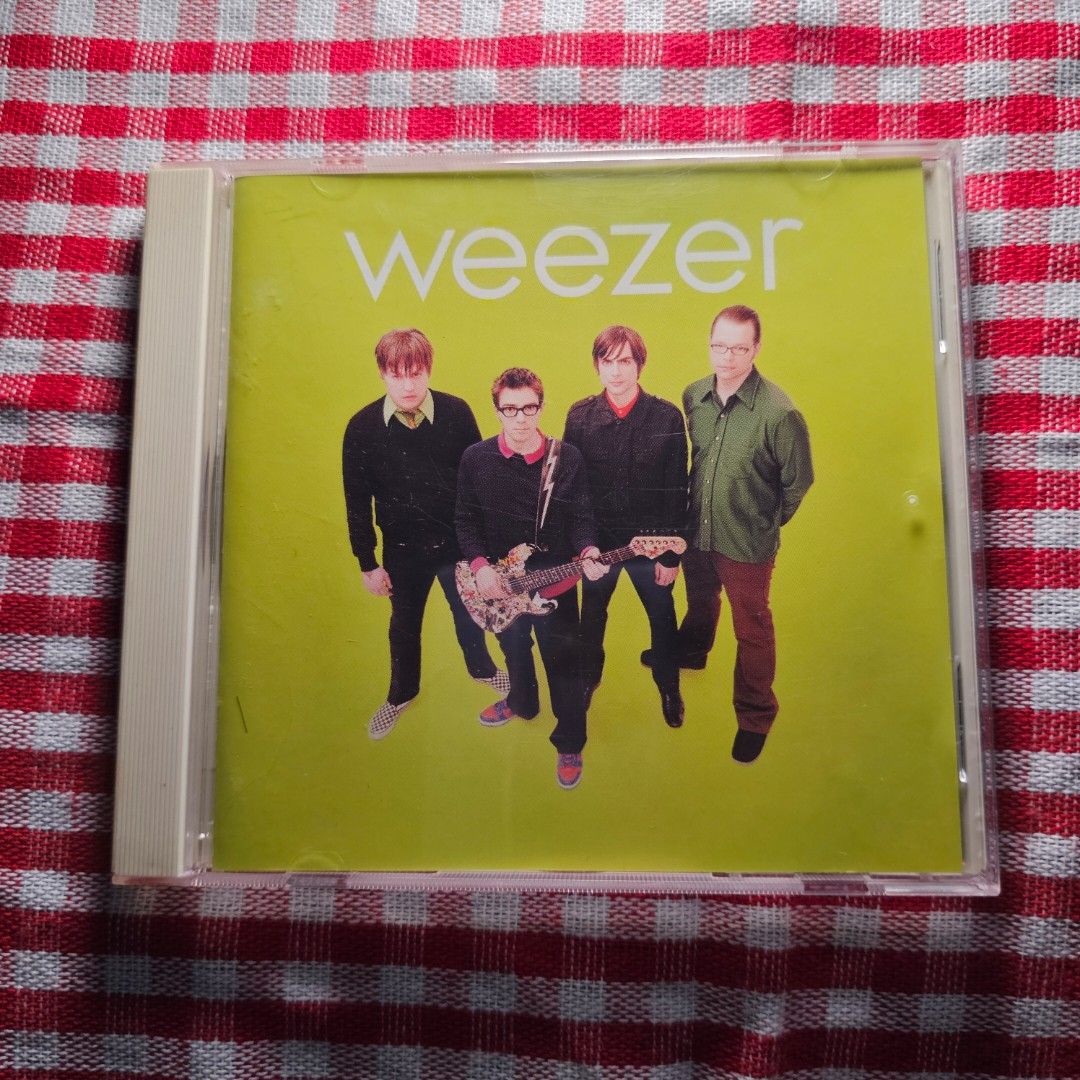 Weezer - Weezer (Green Album) CD - CD Mint (Category: CDs & DVDs) located in Quezon City. Submitted by serefrenpaz (Listing ID 1423849804, Image 1). Description: CD of Weezer's self-titled album, also known as the Green Album. The CD features tracks like "Don't Let Go," "Photograph," and "Island in the Sun." The album art features the band members on a green background. The CD is in its original jewel case and includes the booklet with lyrics and