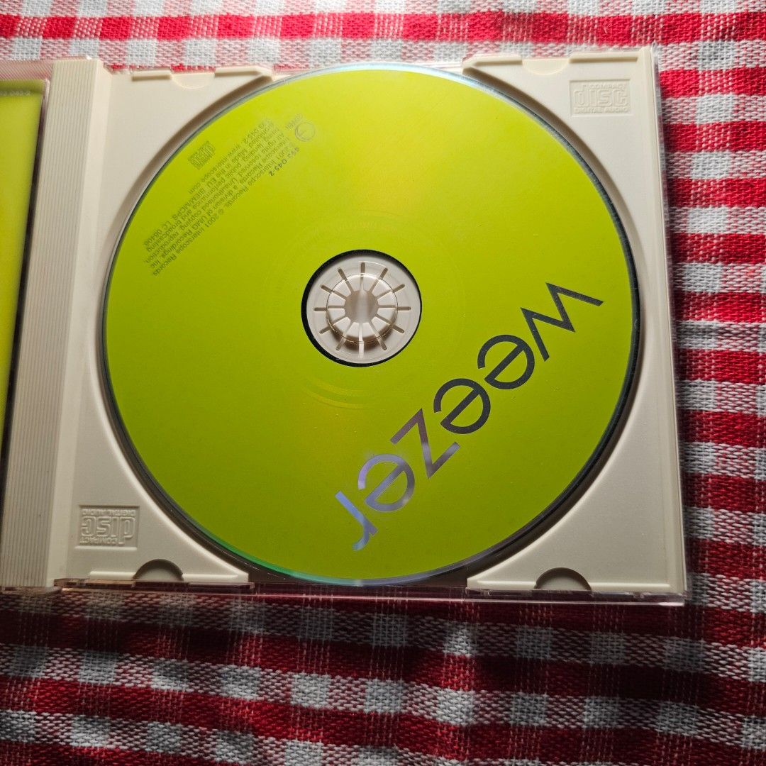 Weezer - Weezer (Green Album) CD - CD Mint (Category: CDs & DVDs) located in Quezon City. Submitted by serefrenpaz (Listing ID 1423849804, Image 2). Description: CD of Weezer's self-titled album, also known as the Green Album. The CD features tracks like "Don't Let Go," "Photograph," and "Island in the Sun." The album art features the band members on a green background. The CD is in its original jewel case and includes the booklet with lyrics and