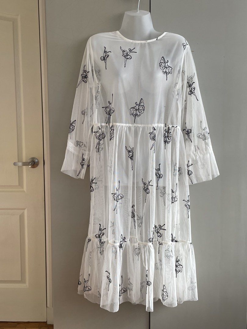 White Sheer Embroidered Ballet Dress (Category: Dresses) located in Paranaque City. Submitted by beamiscellaneous (Listing ID 1423862035, Image 1). Description: White dress with embroidered ballet dancer design. Features a round neckline, long sleeves, and a flowing, tiered skirt made of sheer fabric. 45” length. RFS: decluttering.