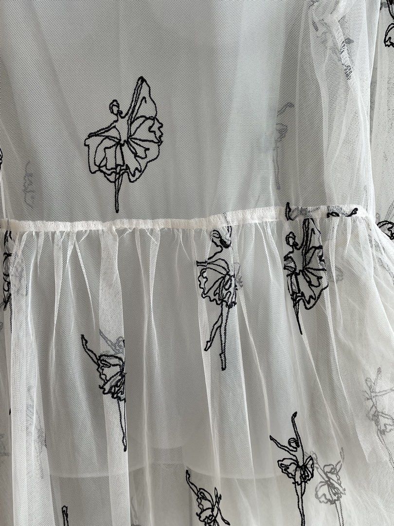 White Sheer Embroidered Ballet Dress (Category: Dresses) located in Paranaque City. Submitted by beamiscellaneous (Listing ID 1423862035, Image 2). Description: White dress with embroidered ballet dancer design. Features a round neckline, long sleeves, and a flowing, tiered skirt made of sheer fabric. 45” length. RFS: decluttering.