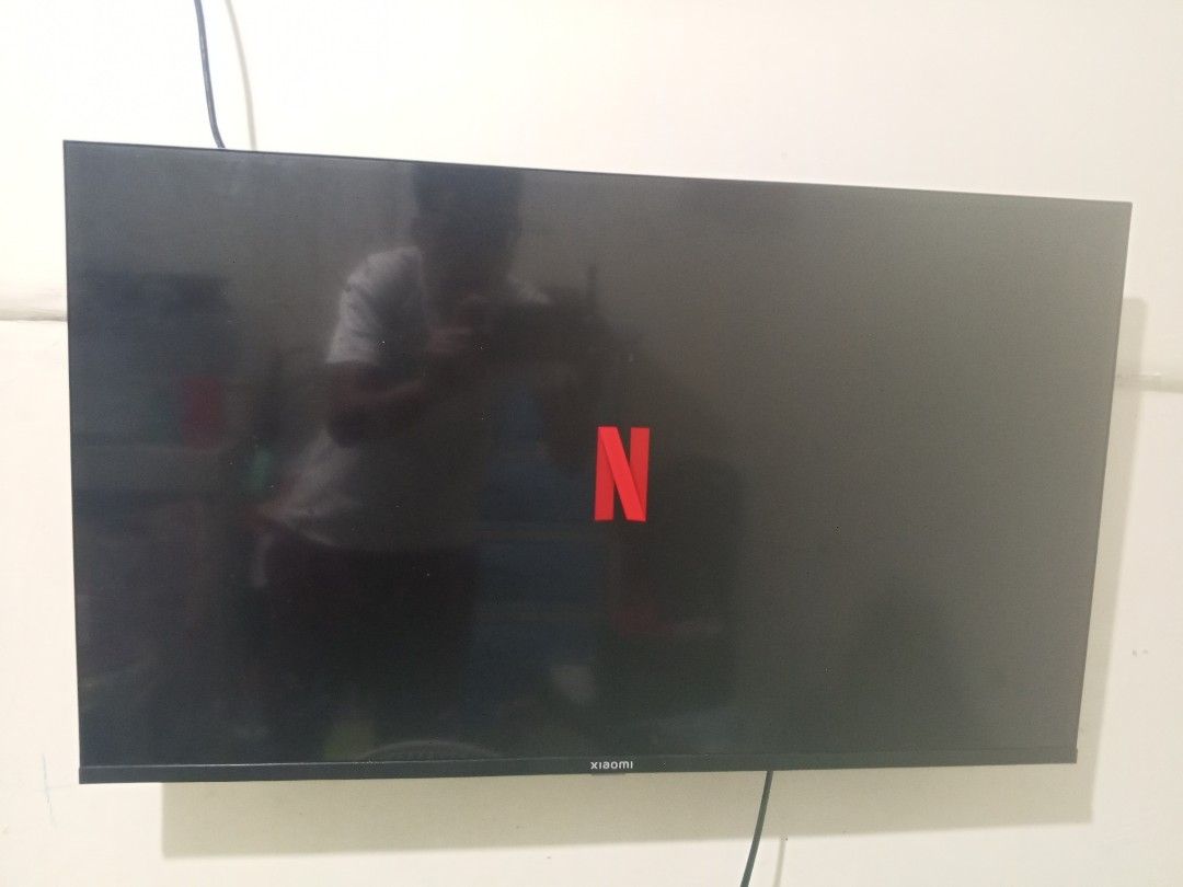 Xiaomi Smart TV / Google TV (Category: TV) located in Manila. Submitted by zeus025 (Listing ID 1423958103, Image 2). Description: - Xiaomi Smart TV with Google TV - Netflix pre-installed - Wall-mounted - Currently showing Netflix home screen and a scene from "The Mentalist" Unit and Remote only.