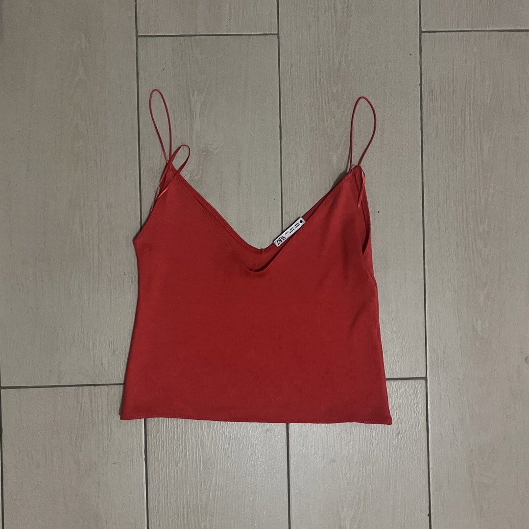 Zara Orange Cami Top (Category: Sleeveless) located in Makati City. Submitted by sixelaa (Listing ID 1423842012, Image 1). Description: - Zara orange cami top - V-neck design - Features spaghetti straps - Versatile style: dress up or down - Ideal for layering - Made from a smooth, lightweight fabric.