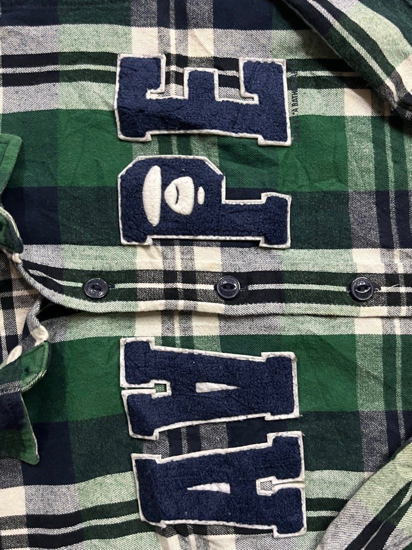 Aape by A Bathing Ape Plaid Shirt (Category: Tshirts & Polo Shirts ) located in Iloilo. Submitted by cloud.thrifts (Listing ID 1419541633, Image 2). Description: - Authentic Aape by A Bathing Ape shirt - Classic green, white, and navy blue plaid pattern - Features the Aape logo on the chest - Long sleeves with button-down closure - Includes a small logo tag - Made in China.