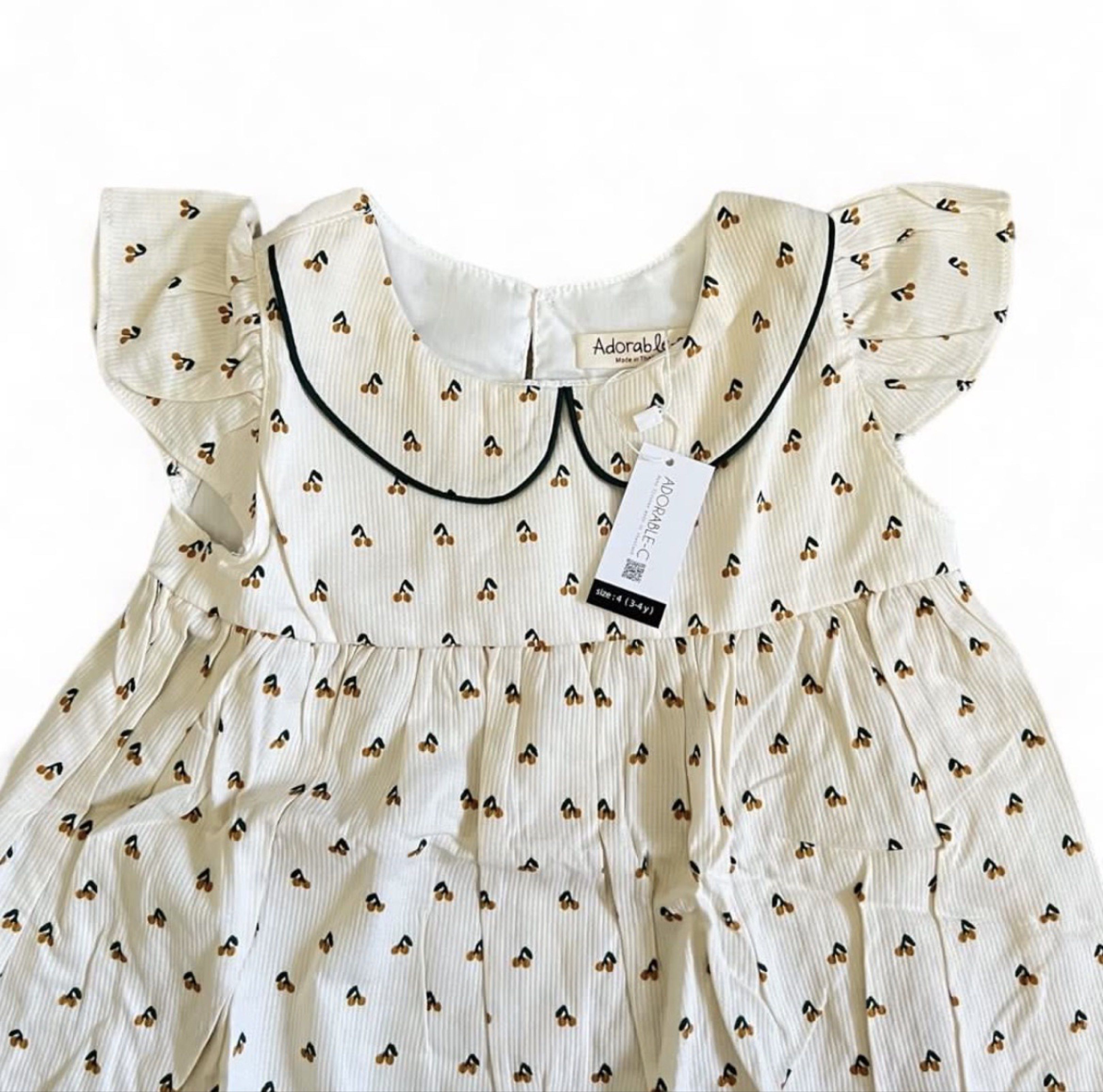 Adorable & Co. Cherry Print Dress (Category: Babies & Kids Fashion) located in Davao. Submitted by allthisandmore (Listing ID 1419441910, Image 1). Description: - Adorable & Co. dress - Cherry print - Cream color, corduroy texture - Peter Pan collar with black trim - Flutter sleeves - Size: 3-4 years old - Relaxed fit.