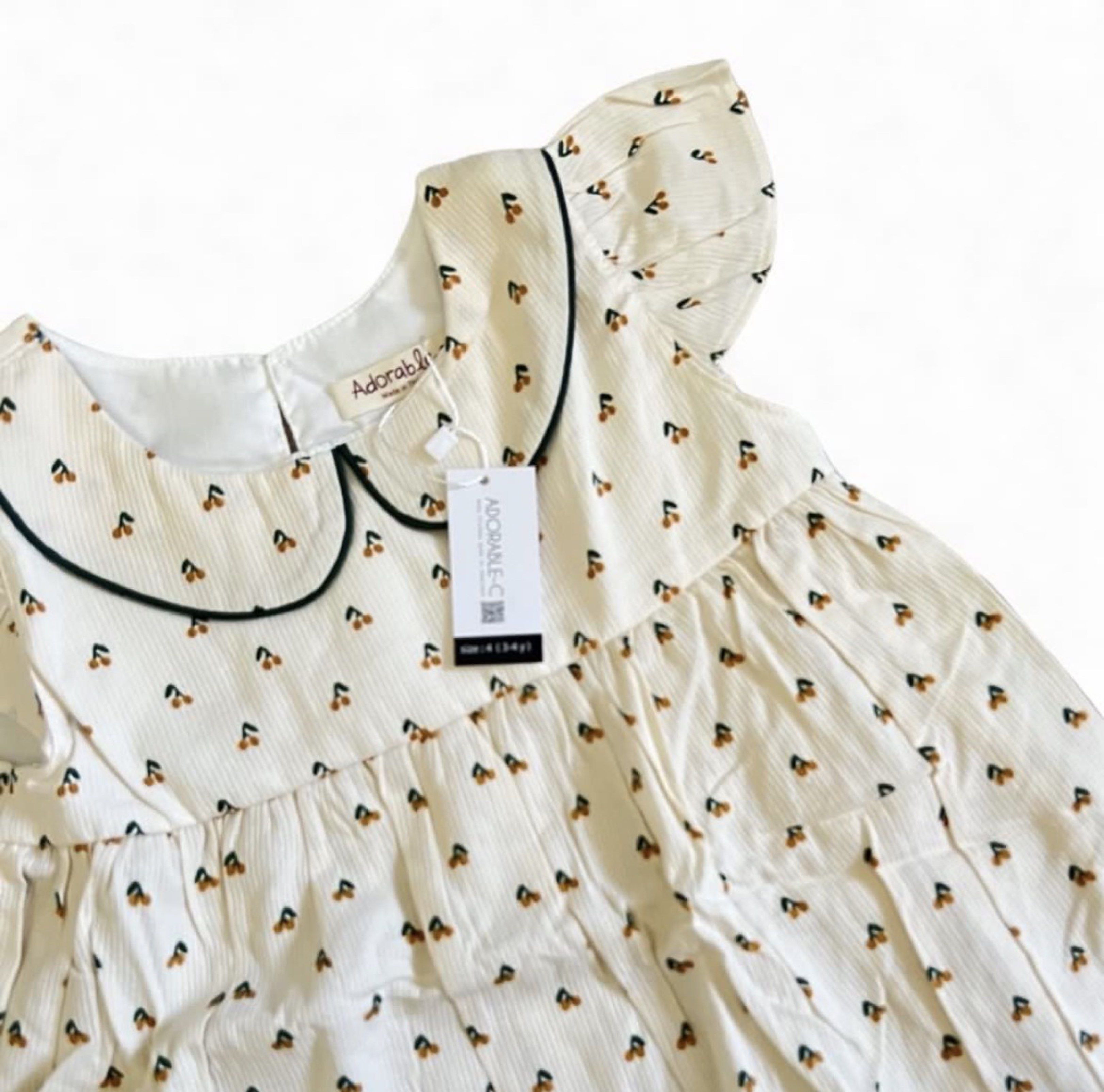 Adorable & Co. Cherry Print Dress (Category: Babies & Kids Fashion) located in Davao. Submitted by allthisandmore (Listing ID 1419441910, Image 2). Description: - Adorable & Co. dress - Cherry print - Cream color, corduroy texture - Peter Pan collar with black trim - Flutter sleeves - Size: 3-4 years old - Relaxed fit.