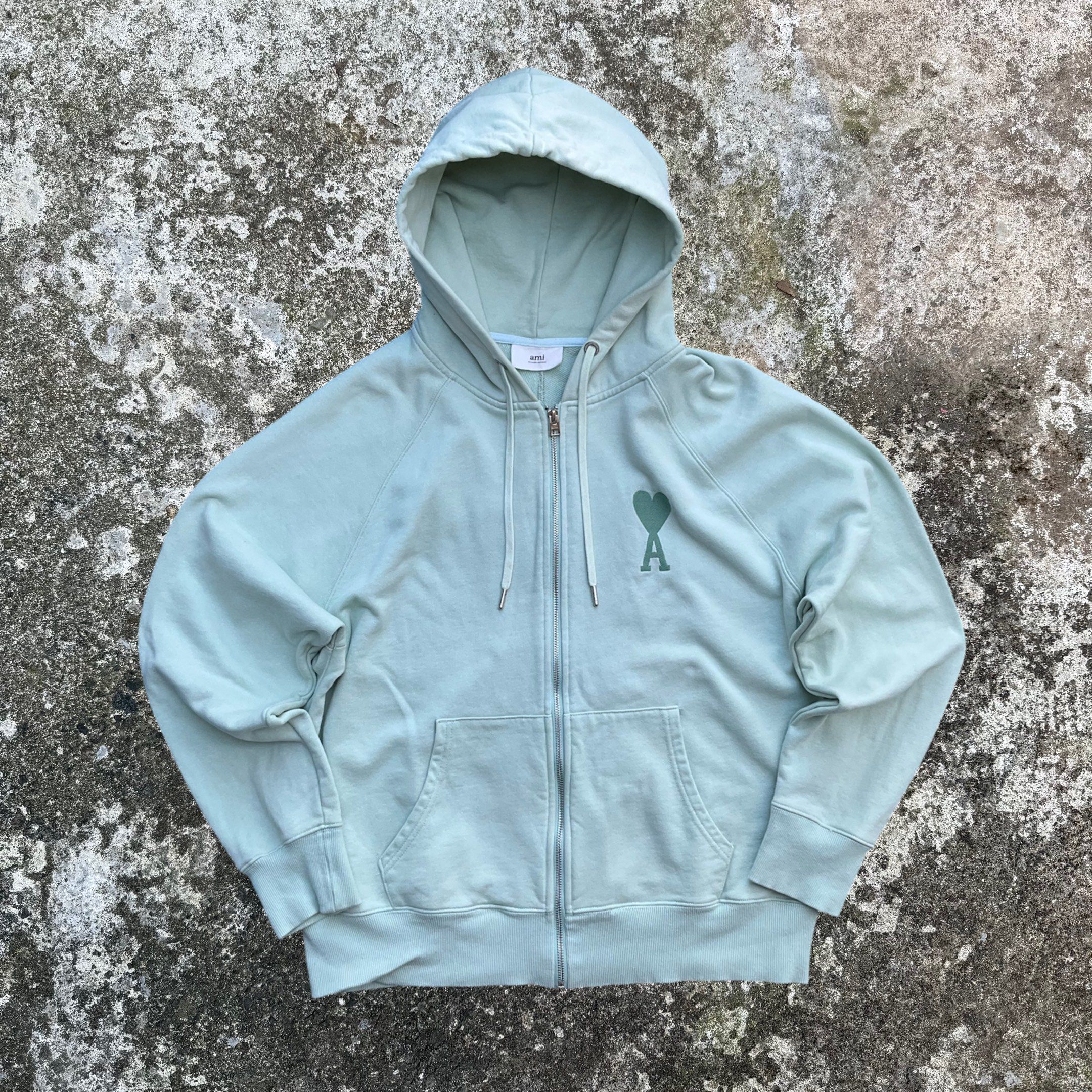 Ami Paris Full-Zip Hoodie (Category: Coats, Jackets and Outerwear) located in Baguio. Submitted by appetentraiments (Listing ID 1419434924, Image 1). Description: Excellent condition 27.5"Lx24.5"W | L on tag 8/10 color rate | needs wash Rare colorway! (mint green).