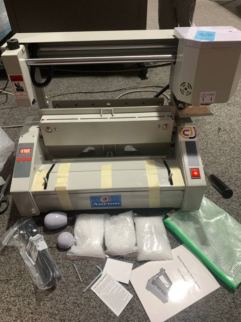 Aurum Binding Machine (Category: Office & Business Technology) located in Quezon City. Submitted by copieronlineinc (Listing ID 1419395950, Image 1). Description: - Aurum binding machine - Digital display - Red power indicator - Includes: - Binding materials (multiple bags) - Power cord - Manual - Two white accessories - Green sheet - Good working condition.