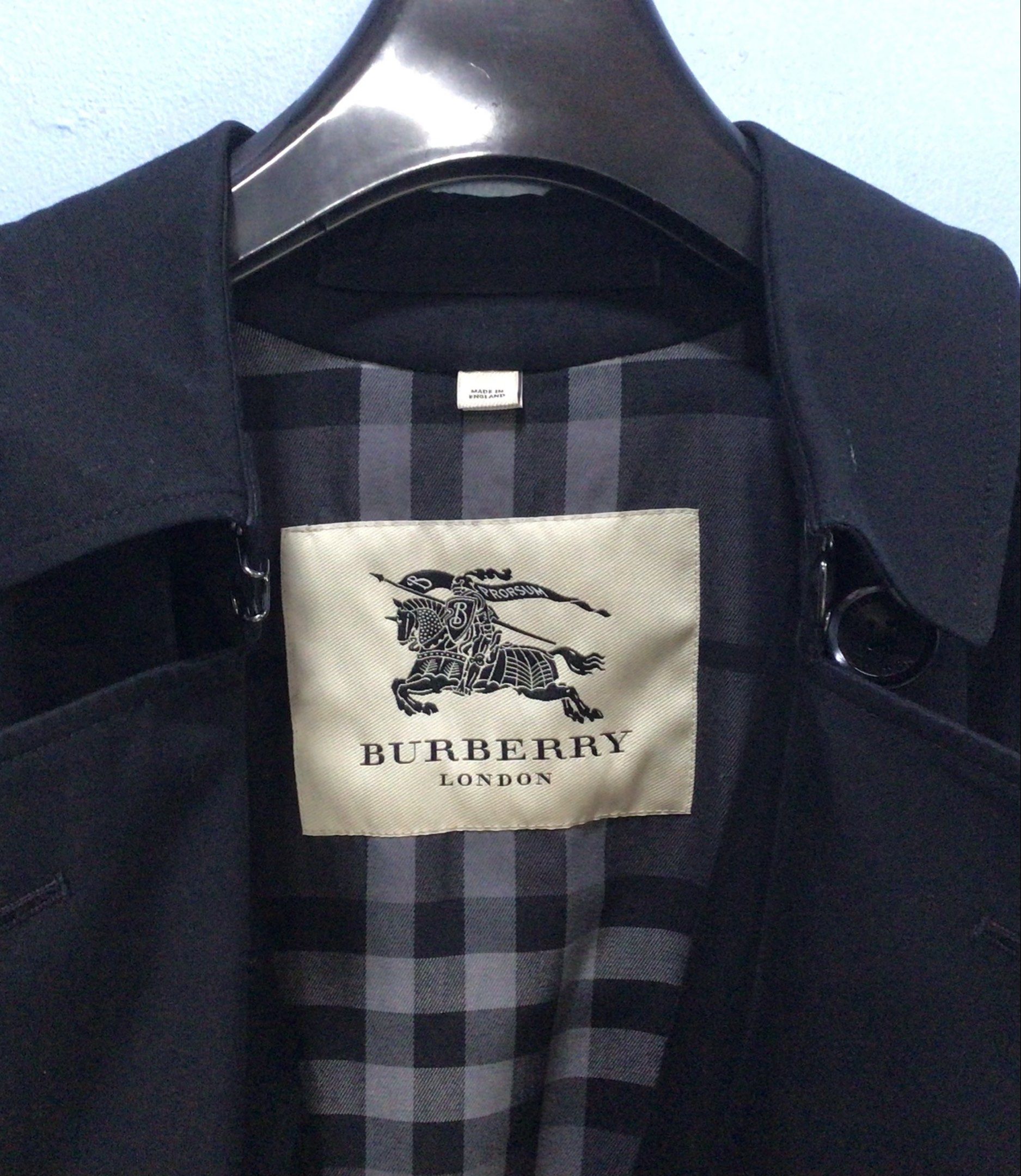 Burberry London Trench Coat (Category: Coats, Jackets and Outerwear) located in Makati City. Submitted by ilaw72 (Listing ID 1419411041, Image 2). Description: MADE IN ENGLAND •Authentic Burberry London trench coat •Elegant black color •Cotton •Twill weave •Storm flap •Classic collar •Double-breasted style button fastening •Detachable waist belt •Belt loops •Epaulettes •Long sleeves •Belted cuffs •Two front button-fastening jetted pockets •Button