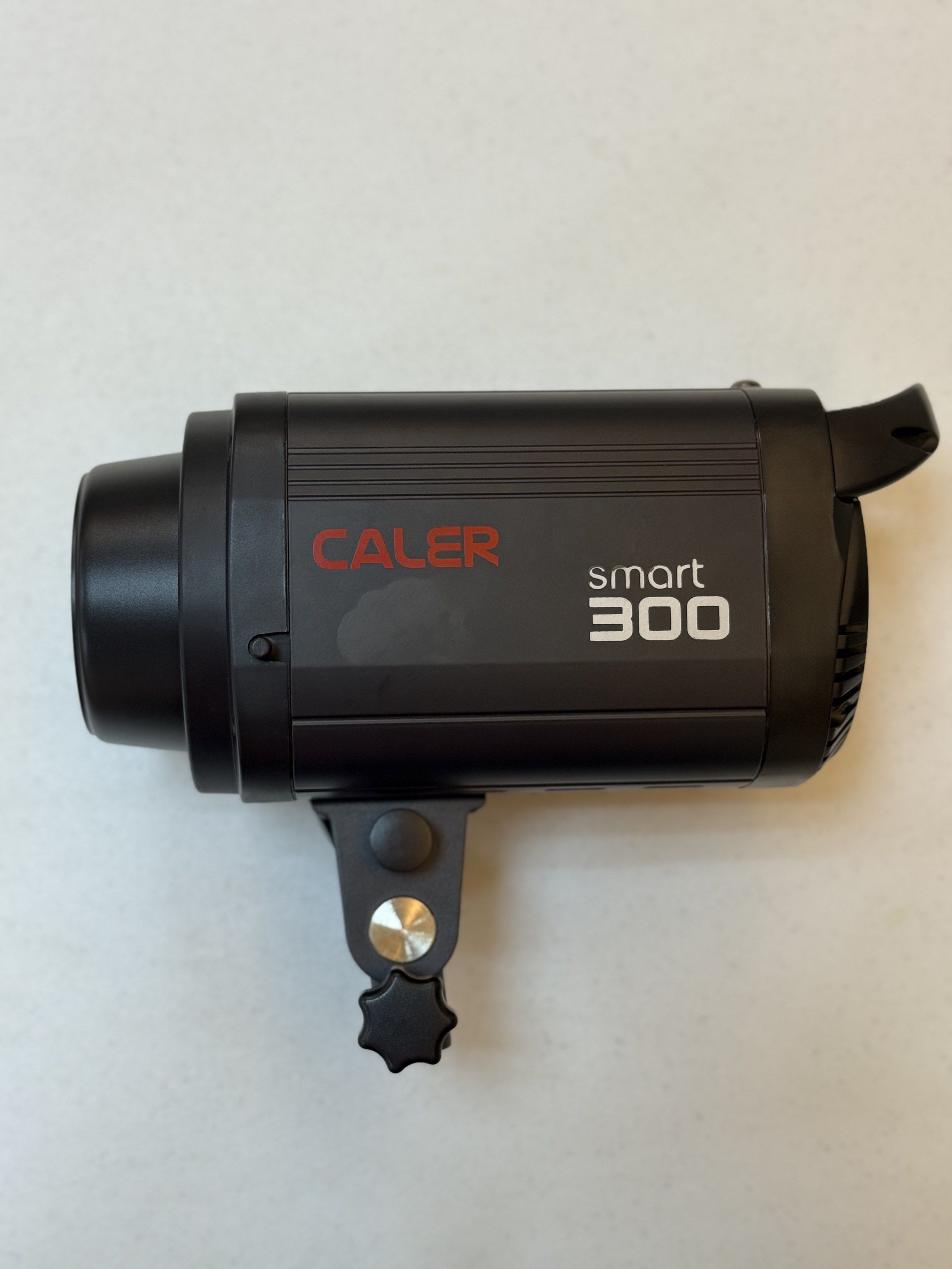 CALER Smart 300 Studio Flash (Set of 3) (Category: Lighting & Studio Equipment) located in Taguig. Submitted by dreamstudios (Listing ID 1419533375, Image 1). Description: Set of 3 - CALER Smart 300W studio flash. Lightly used. Includes all power cords, modeling lamps and covers Features adjustable power settings, a modeling lamp, and a sync port. Includes a protective cover for the flash head. The back panel shows power settings and a USB port. 
