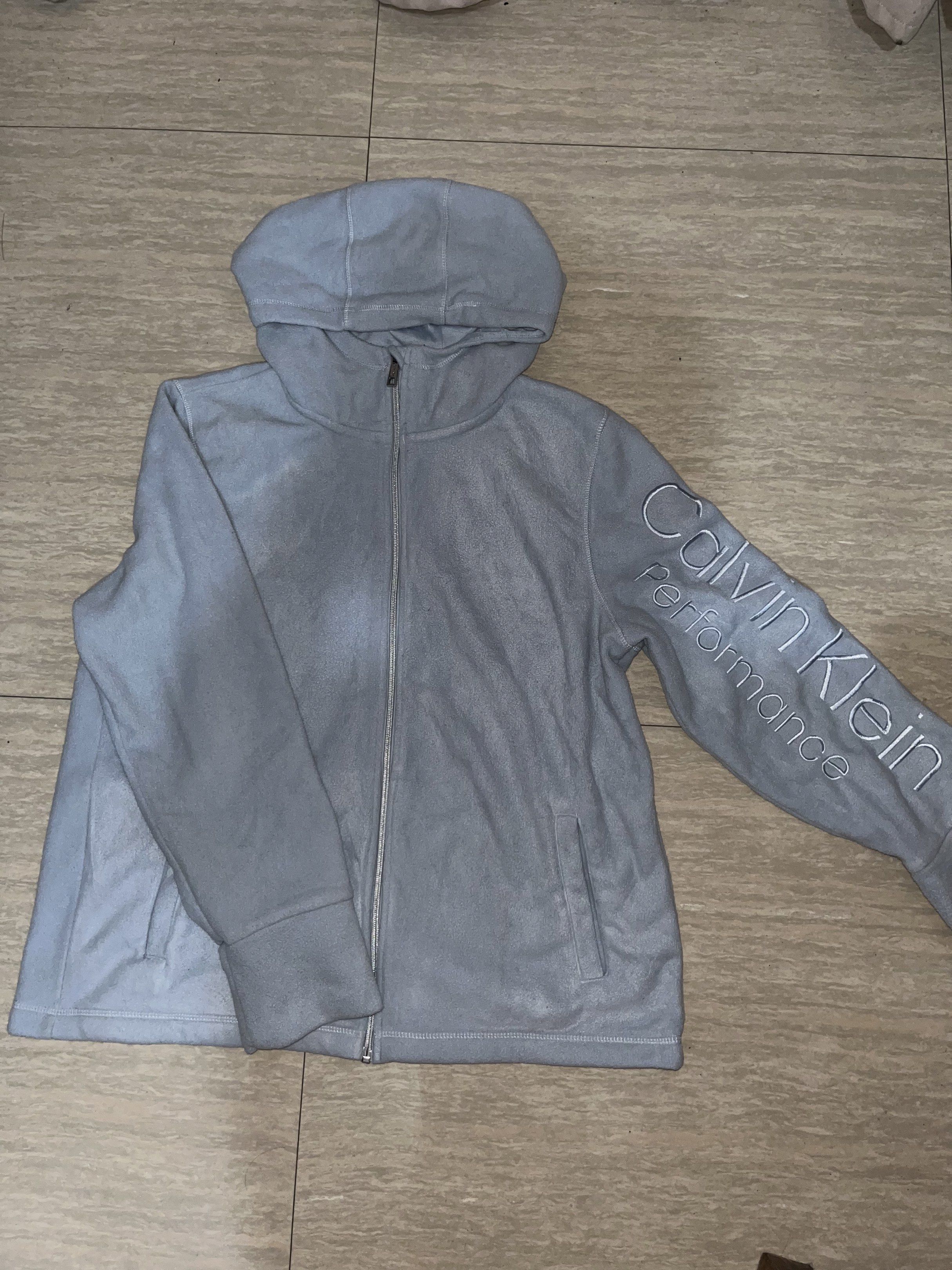 Calvin Klein Performance Hoodie (Category: Coats, Jackets and Outerwear) located in Lipa City. Submitted by coolthreadss (Listing ID 1419460495, Image 2). Description: - Light blue Calvin Klein Performance hoodie - Full zip closure - Hooded - Calvin Klein Performance logo on sleeve - Size: XXL/XG/XXG - Two front pockets.