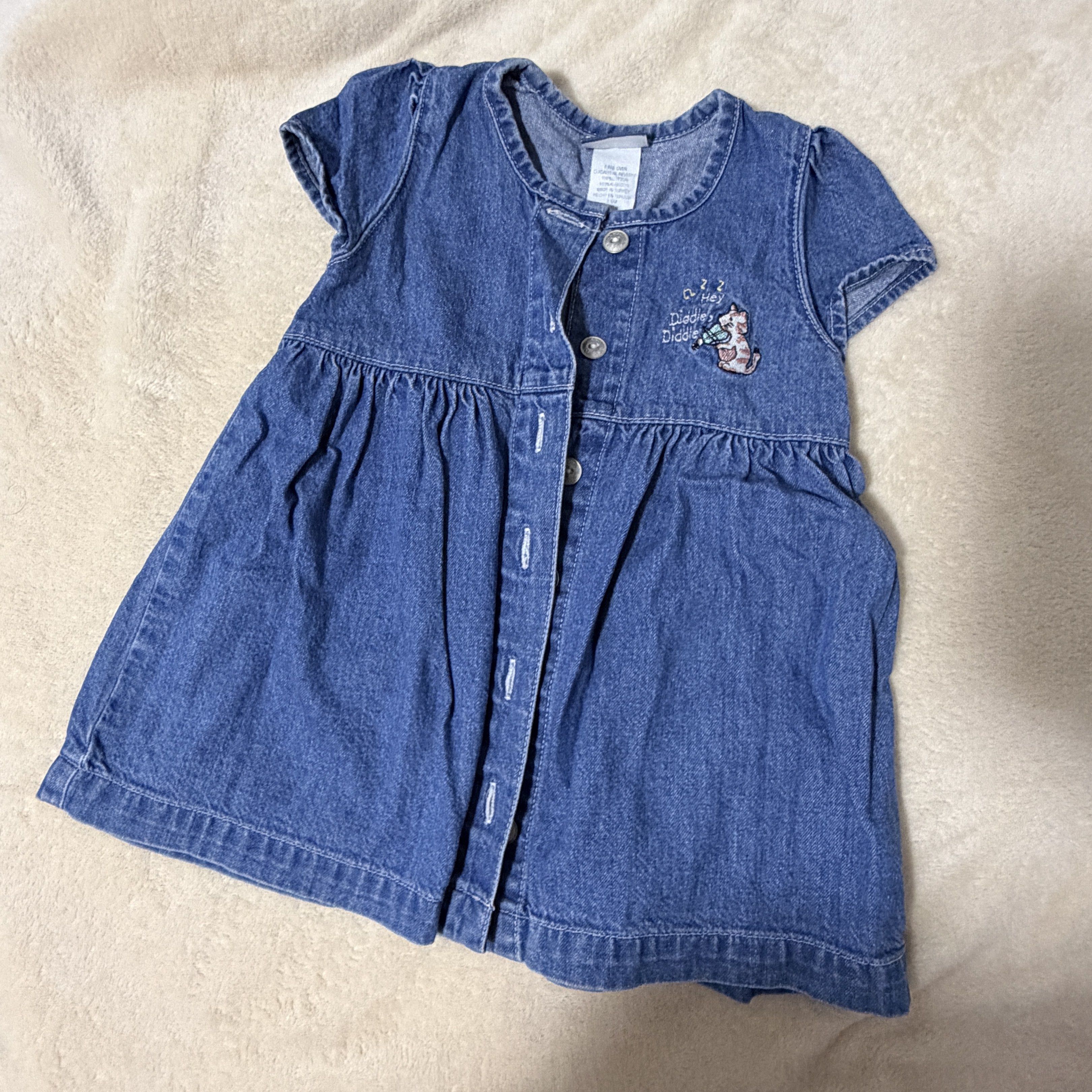 Carter's Classic Denim Dress (Category: Babies & Kids Fashion) located in Batangas. Submitted by chloclo.declutter (Listing ID 1419530079, Image 1). Description: 12-18 months - Carter's denim dress - Button-down front - Short sleeves - Embroidered cat playing violin - Gathered waist - Classic denim wash - Made in Turkey - Perfect for your little girl! Loc: Batangas Shipping via J&T.