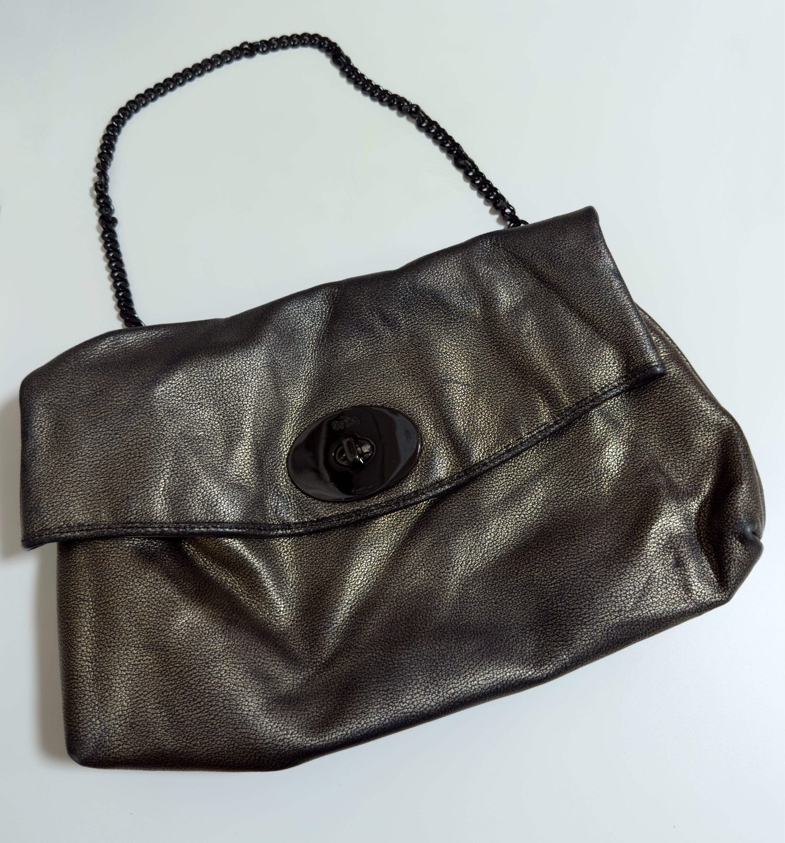 Coach Metallic Shoulder Bag (Category: Luxury Bags & Wallets) located in Mandaluyong City. Submitted by gee028 (Listing ID 1419486604, Image 1). Description: - Coach shoulder bag with metallic finish - Unique clasp closure - Chain strap - Interior zippered pocket - Includes Coach label - Sleek design for various occasions - Made with high-quality materials.