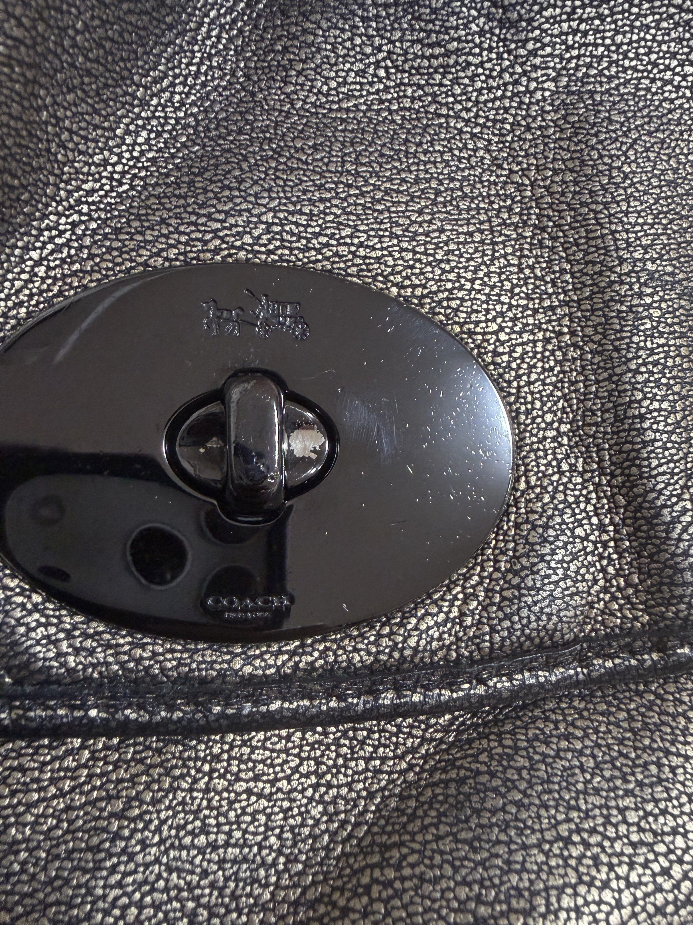 Coach Metallic Shoulder Bag (Category: Luxury Bags & Wallets) located in Mandaluyong City. Submitted by gee028 (Listing ID 1419486604, Image 3). Description: - Coach shoulder bag with metallic finish - Unique clasp closure - Chain strap - Interior zippered pocket - Includes Coach label - Sleek design for various occasions - Made with high-quality materials.