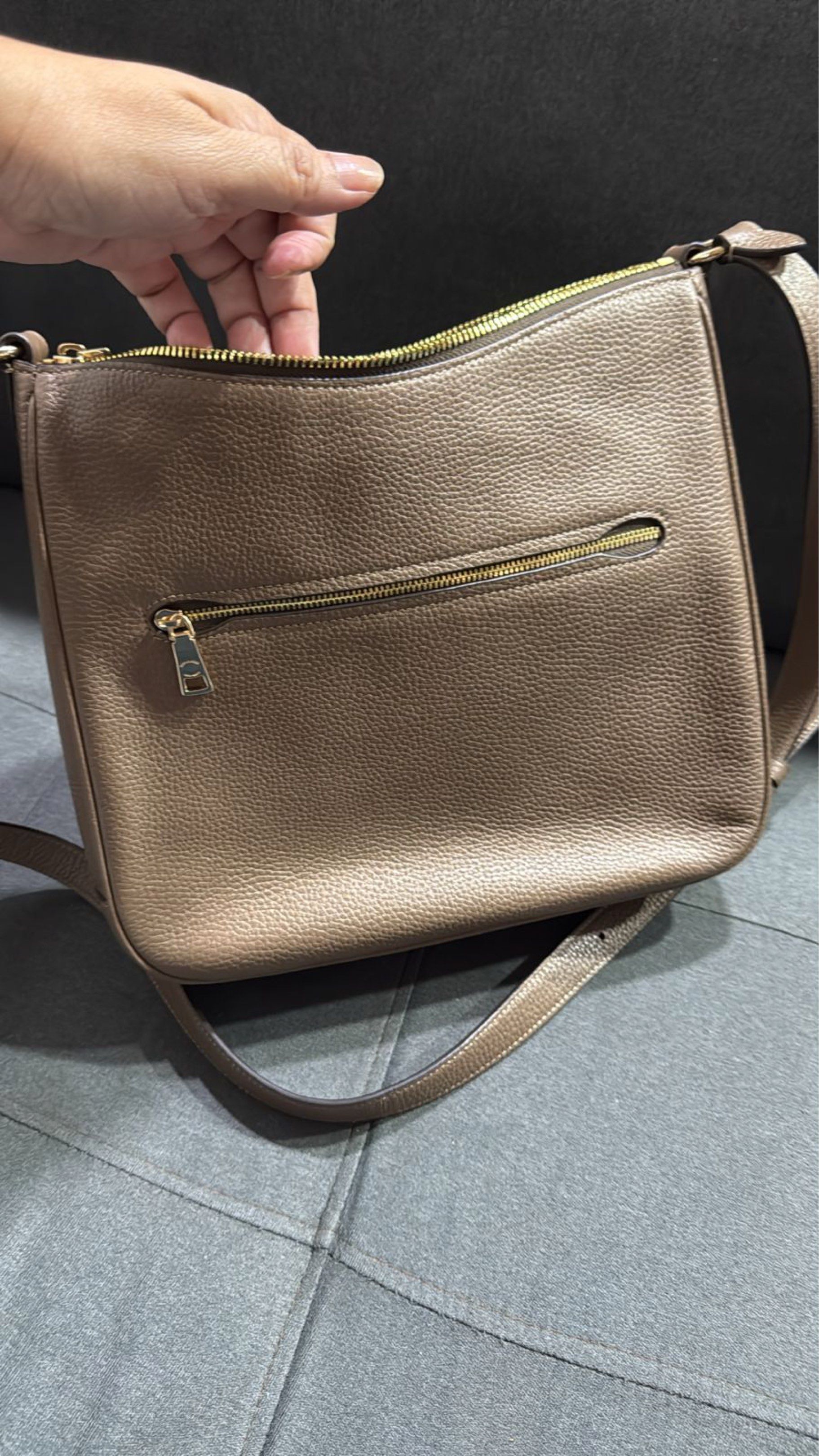Coach Shoulder Bag (Category: Luxury Bags & Wallets) located in Pasay City. Submitted by conifrancis (Listing ID 1419513401, Image 2). Description: - Coach shoulder bag - Neutral / brown color - Zip closure and the back also has a zipper pocket - Adjustable shoulder strap - Interior pocket - Includes dust bag and Coach paper bag - Made of Refined Pebble Leather × Nappa Leather.