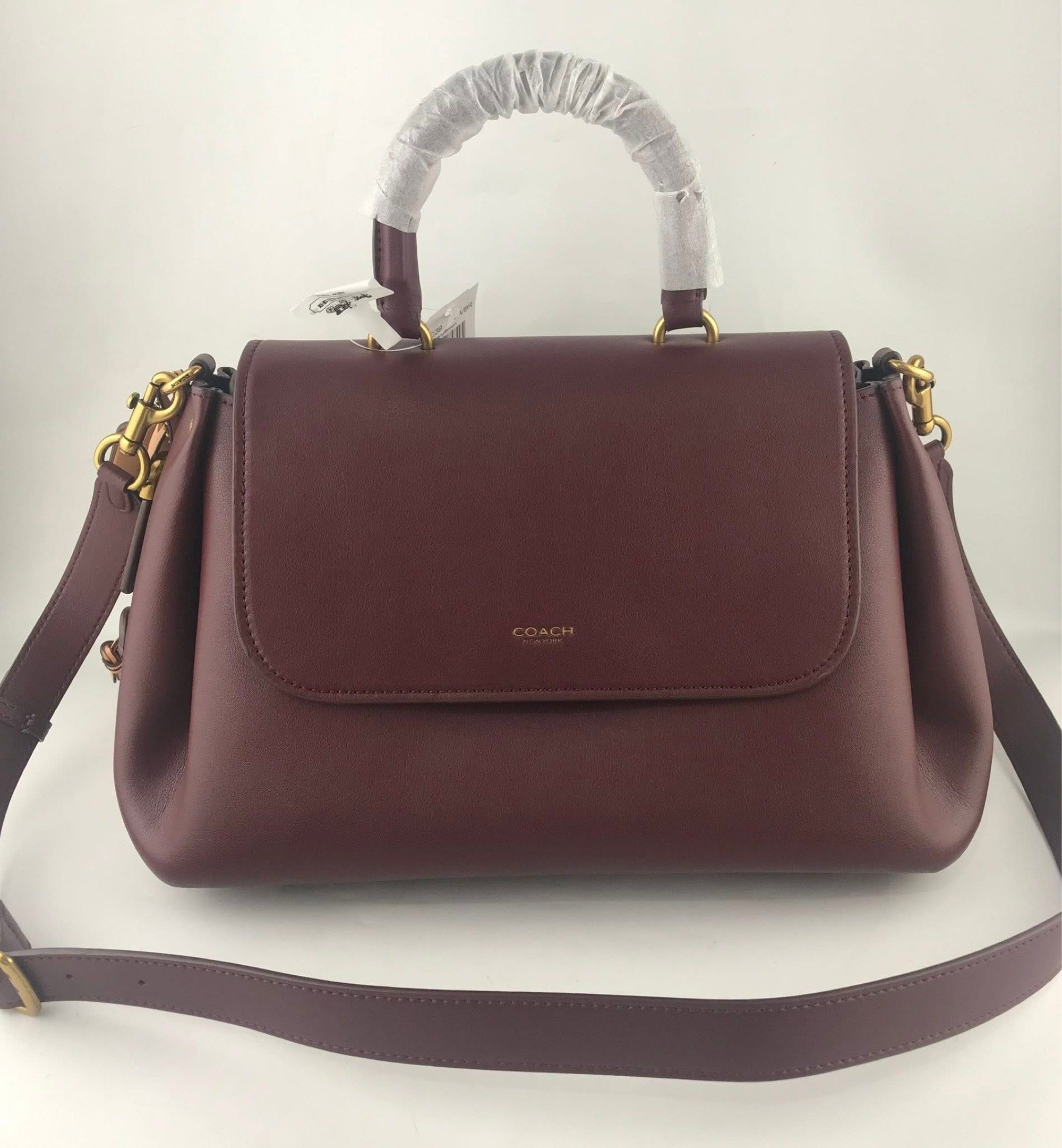 Coach Slouchy Rogue Top Handle Bag (Category: Cross-body Bags) located in Marikina City. Submitted by smthxtra (Listing ID 1419538883, Image 2). Description: Length: 14.0” Height: 8.25” Width: 6.25” Top handle with 4” drop Detachable strap with 21.5” drop for shoulder or crossbody wear Outside zip pocket Inside zip pocket Pushlock closure Four protective feet at base With tag, care card, dust bag, and paper bag included.