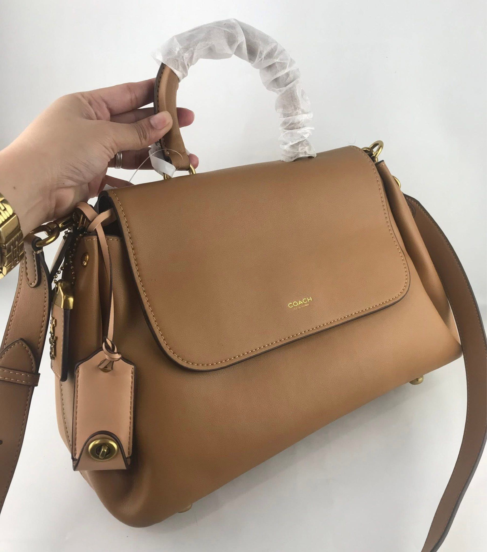 Coach Slouchy Rogue Top Handle Bag (Category: Cross-body Bags) located in Marikina City. Submitted by smthxtra (Listing ID 1419539135, Image 1). Description: Length: 14.0” Height: 8.25” Width: 6.25” Top handle with 4” drop Detachable strap with 21.5” drop for shoulder or crossbody wear Outside zip pocket Inside zip pocket Pushlock closure Four protective feet at base With tag, care card, dust bag, and paper bag included.