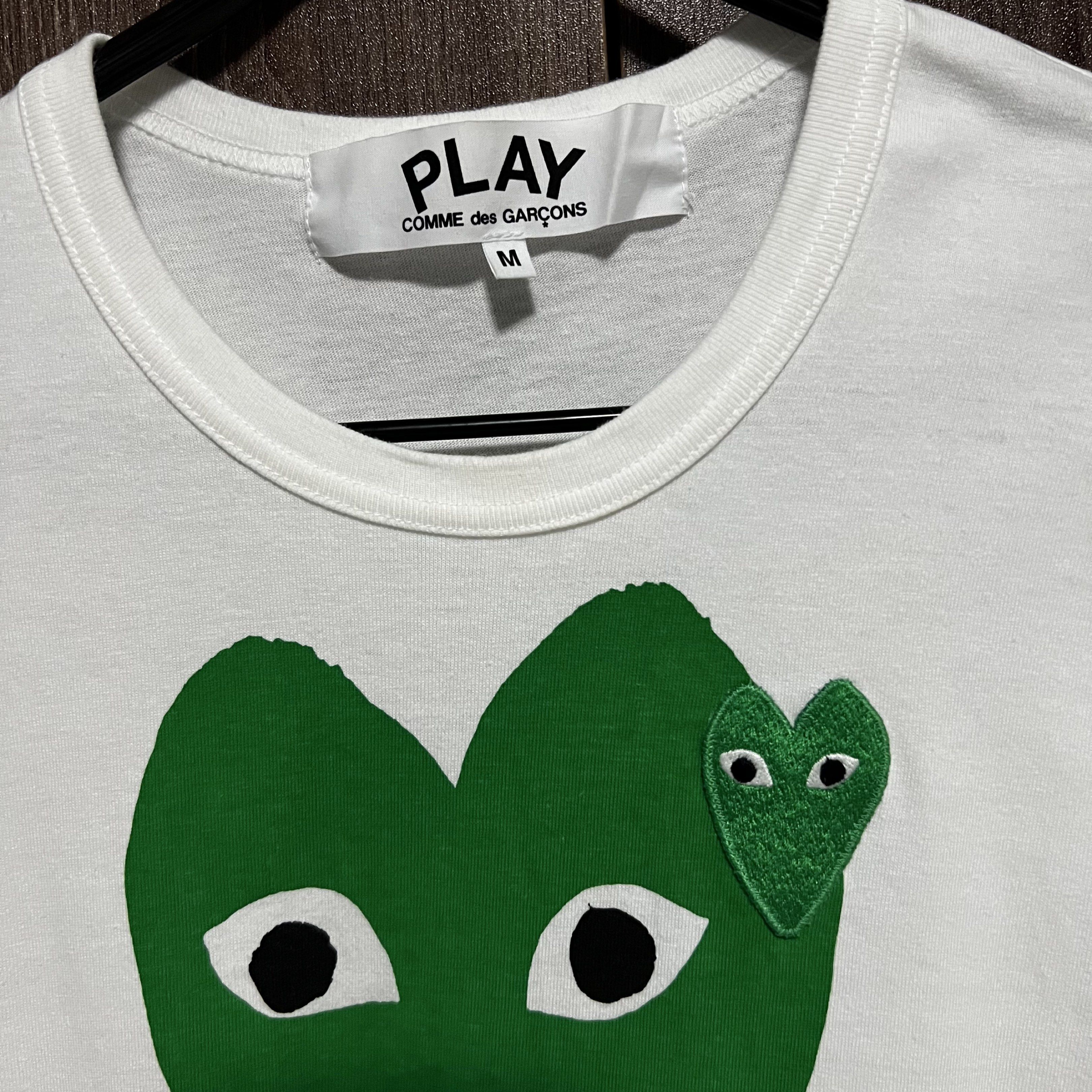 Comme des Garcons Play Green Heart T-shirt (Category: Tshirts & Polo Shirts ) located in Marikina City. Submitted by danielveebz (Listing ID 1419493441, Image 3). Description: - Authentic Comme des Garcons Play T-shirt - Iconic green heart design - Made in Japan - Size: M - Color: White - Features a large green heart on the front and a smaller one with eyes - Comes with original receipt *All clothes are worn once to twice. Handwashed. Definitely 