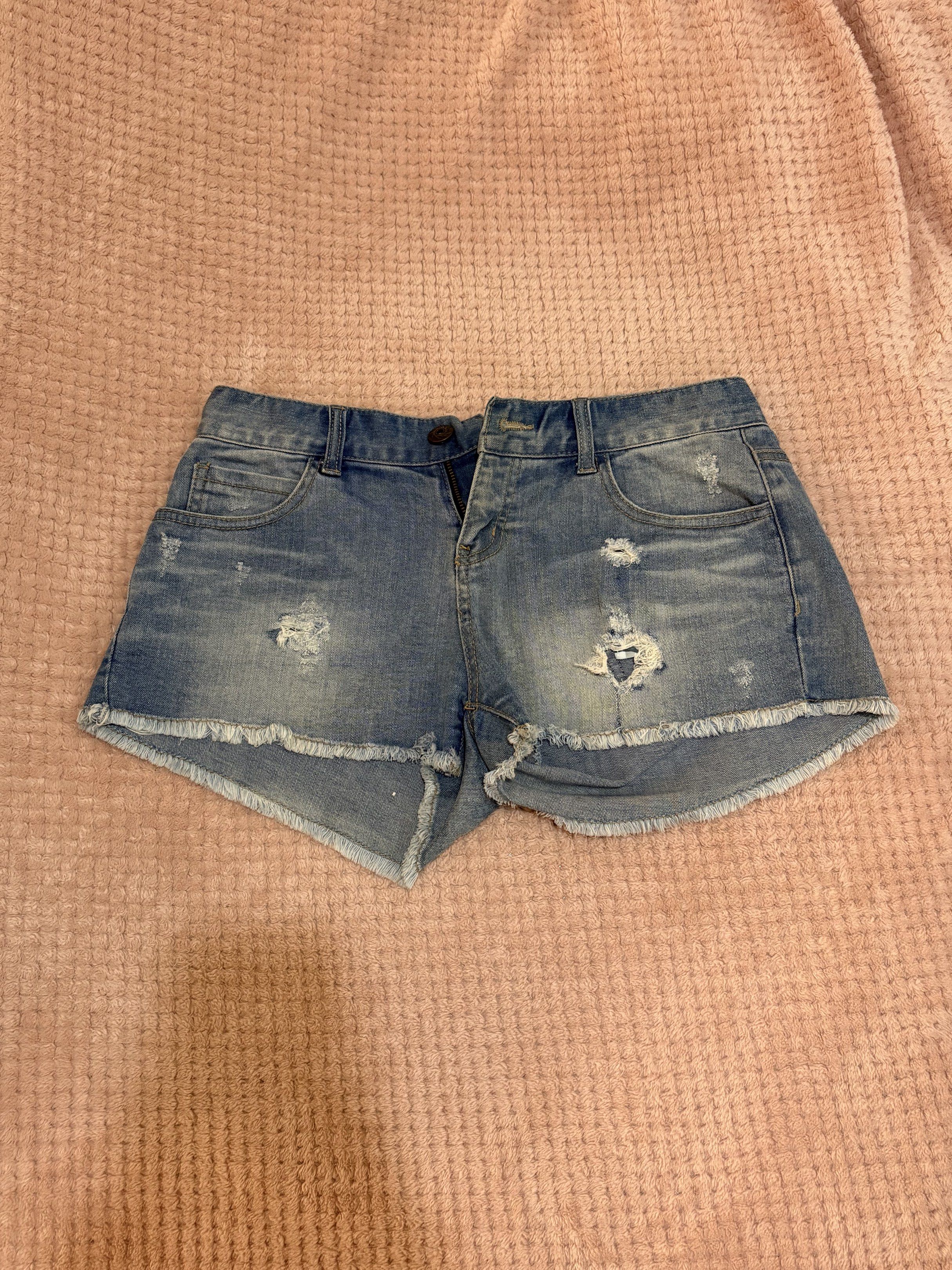 Denim Shorts - BUNDLE OF 3 (Category: Shorts) located in Manila. Submitted by lustreloom (Listing ID 1419530255, Image 2). Description: - Denim shorts available in two styles: classic and distressed. - Features button closure and pockets. - Distressed style includes ripped details. - One pair has a unique paisley pattern on the hem. - Both shorts have a frayed hem. - Perfect for everyday casual wear..