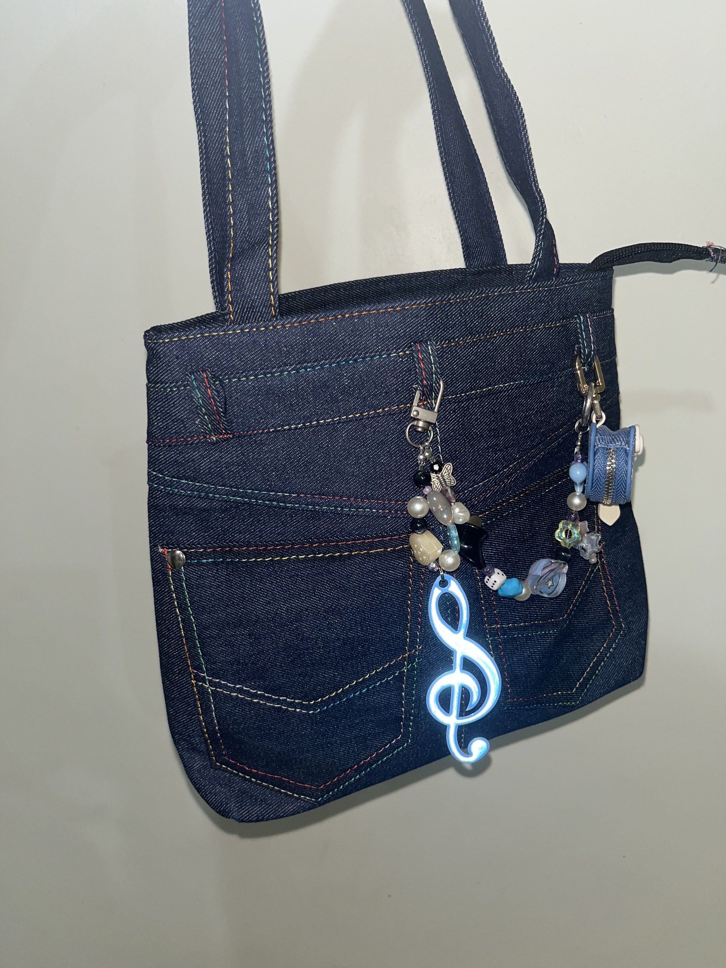 Denim Tote Bag with Charms (Category: Tote Bags) located in Makati City. Submitted by hellogaragekitty (Listing ID 1419572789, Image 2). Description: RARE HK JEANS BAG (wt anik anik) 🦋🩵✨ Reminders! ~ this item is handmade with mix of new and recycled products (specifically beads and trinkets) please set expectations accordingly 🧚🏼‍♀️ ~ color and material might differ on actual due to lighting and etc., rest assured what you see on the picture