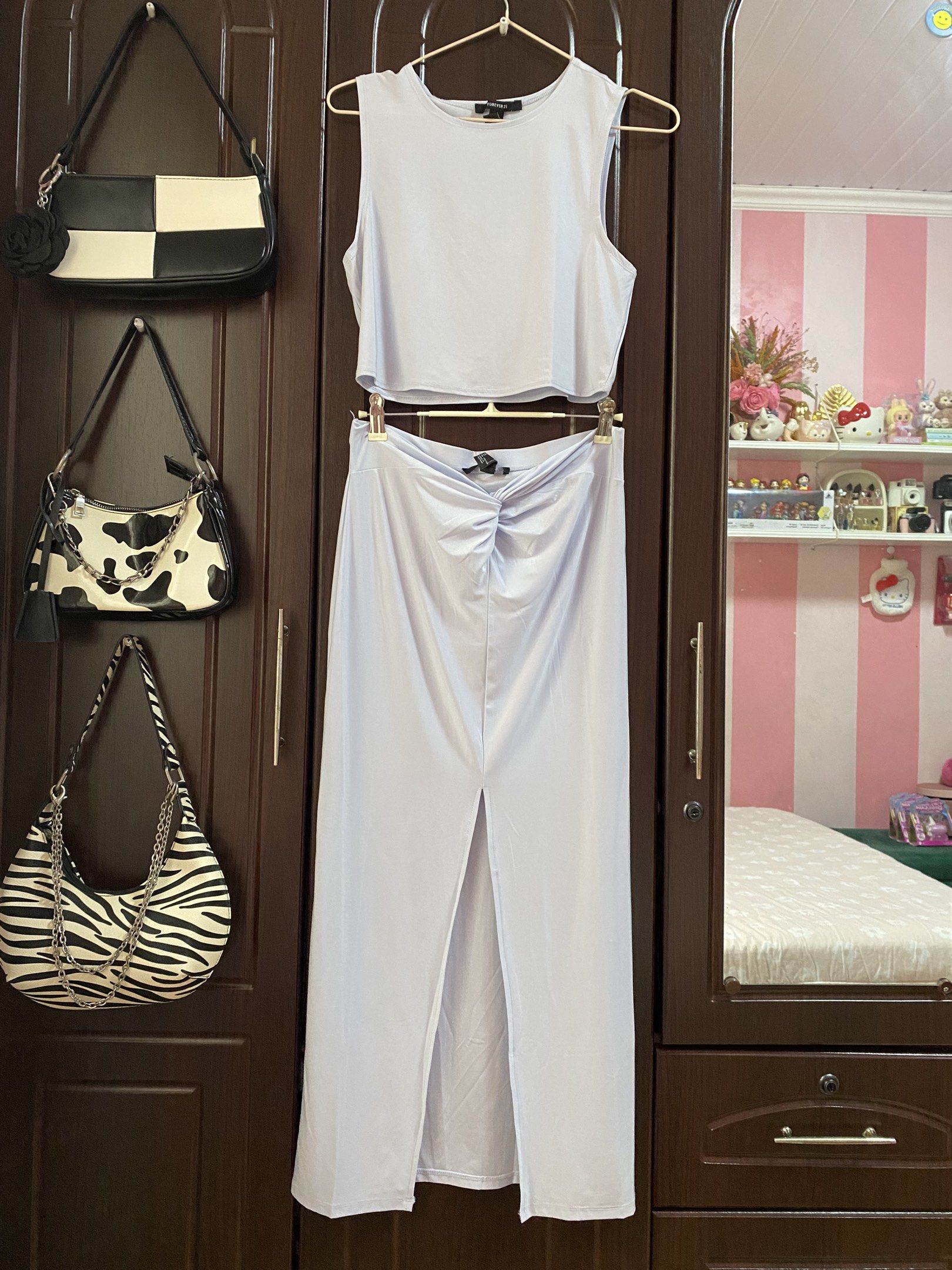 Forever 21 Crop Top and Skirt Set (Category: Sets or Coordinates) located in Taguig. Submitted by prelovedbyveronicag (Listing ID 1419520548, Image 2). Description: - Forever 21 lavender set (top and skirt) - Size: M - Top: Sleeveless, crew neck - Skirt: High-waisted, midi length with front slit and ruched detail.