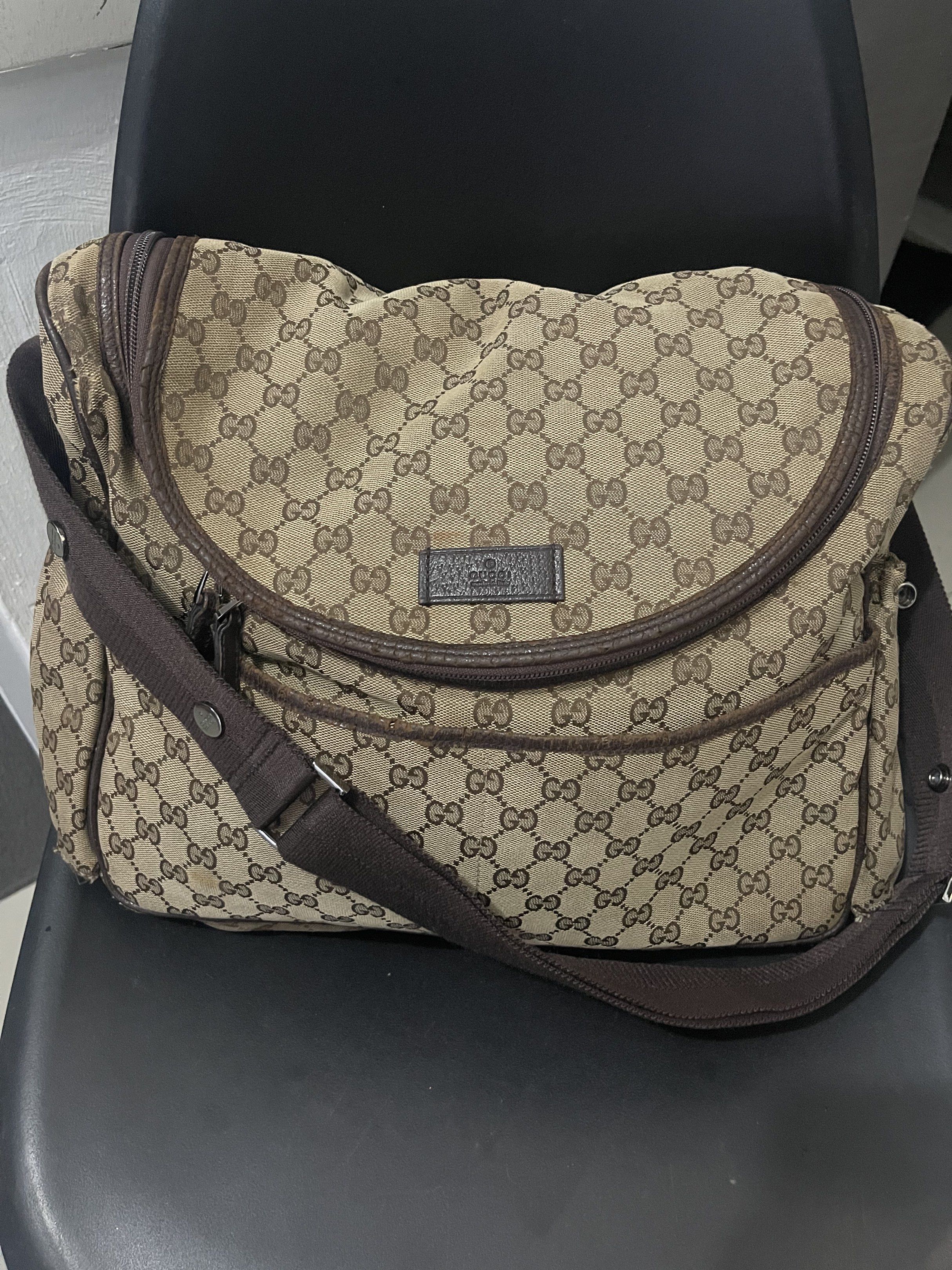 Gucci GG Canvas Messenger Bag (Category: Luxury Bags & Wallets) located in Del Monte. Submitted by mhinaesguerra (Listing ID 1419404565, Image 1). Description: - Authentic Gucci messenger bag - Iconic GG canvas - Brown leather trim - Adjustable brown shoulder strap - Multiple compartments (front pocket, main zippered) - Signs of wear on corners and trim.