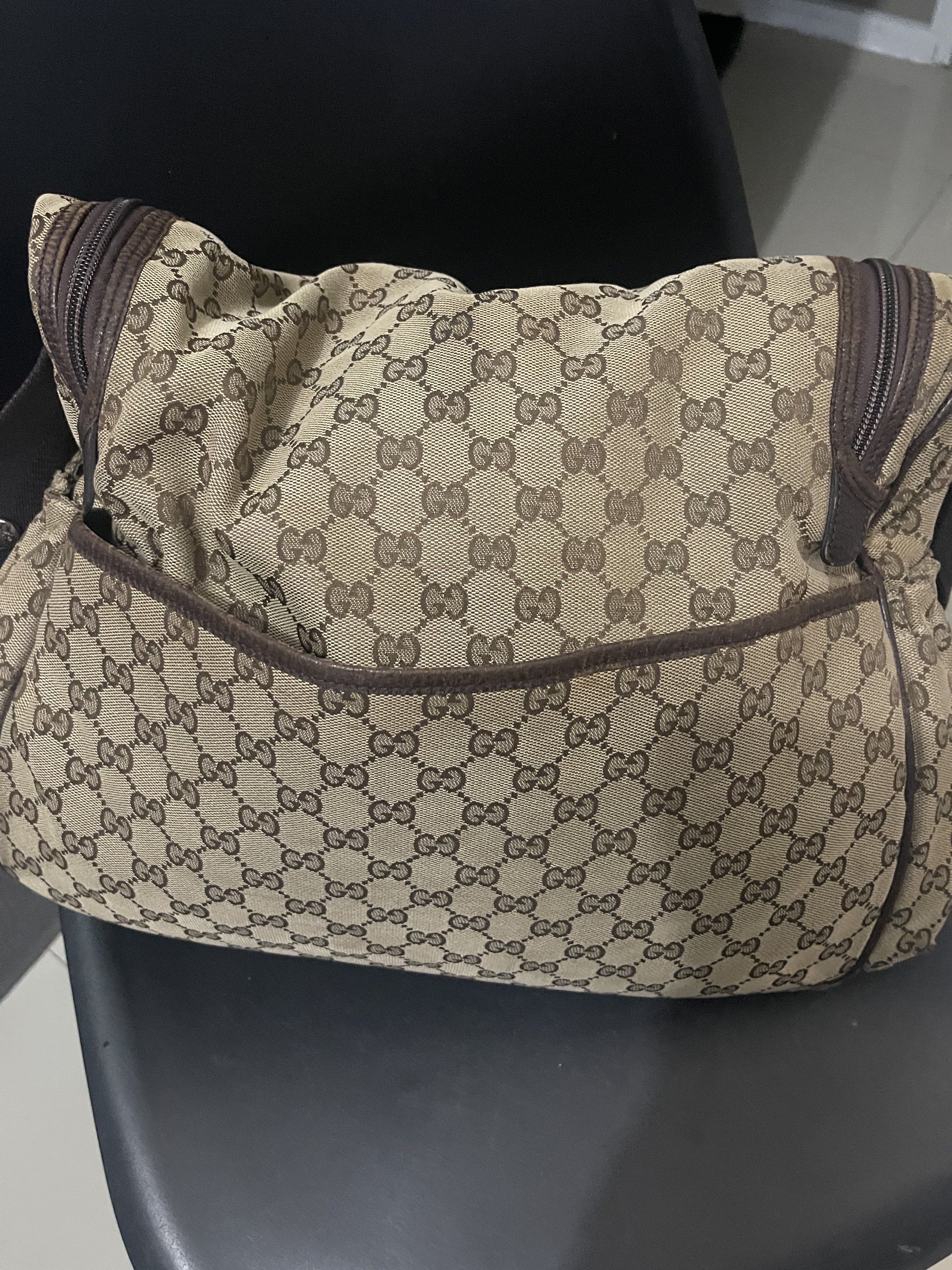 Gucci GG Canvas Messenger Bag (Category: Luxury Bags & Wallets) located in Del Monte. Submitted by mhinaesguerra (Listing ID 1419404565, Image 3). Description: - Authentic Gucci messenger bag - Iconic GG canvas - Brown leather trim - Adjustable brown shoulder strap - Multiple compartments (front pocket, main zippered) - Signs of wear on corners and trim.