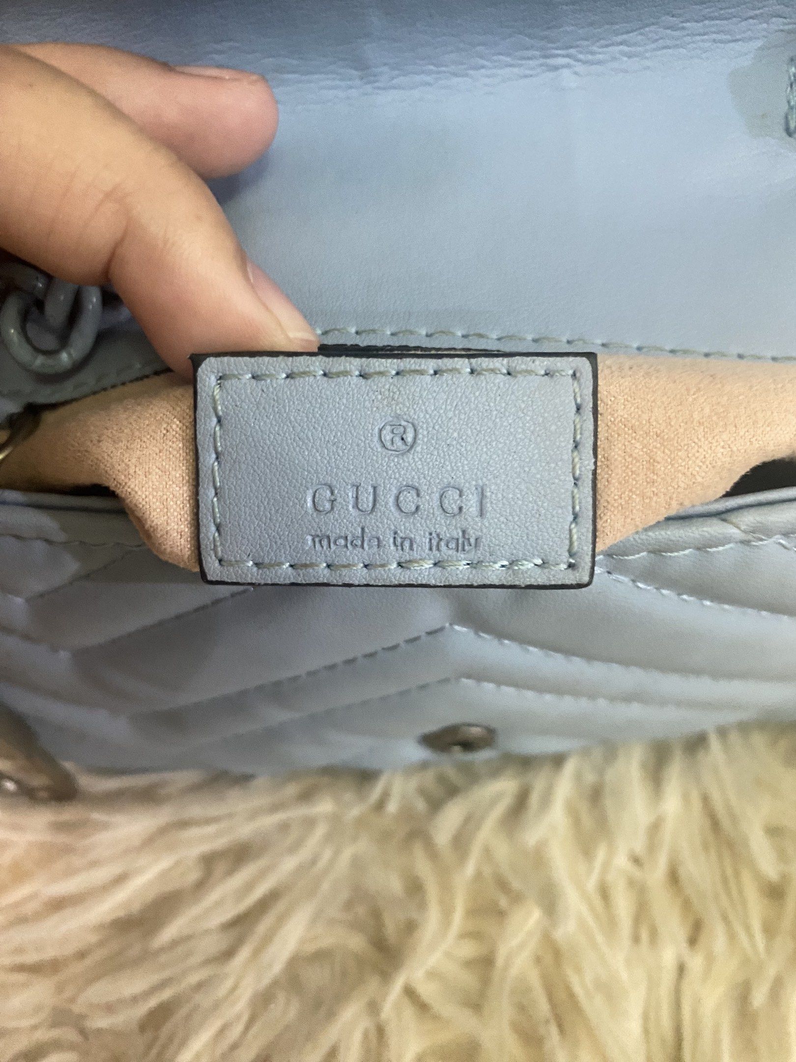 Gucci GG Marmont Mini Bag (Category: Luxury Bags & Wallets) located in Davao. Submitted by cmbrandedluxurycollection (Listing ID 1419517899, Image 3). Description: - Gucci GG Marmont Mini Bag - Light blue quilted design - Iconic GG logo on flap closure - Chain strap - Interior includes a small pocket - Leather tag with Gucci logo and "Made in Italy" inscription - Serial number tag inside.