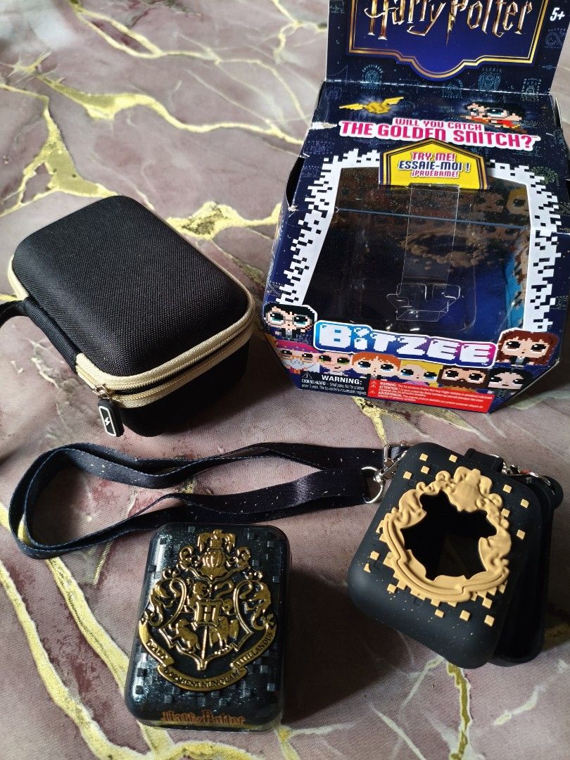 Harry Potter Bitzee Interactive Toy (Category: Western Merchandise) located in General Trias. Submitted by cbyegandco. (Listing ID 1419476069, Image 3). Description: - Harry Potter Bitzee - Features Hogwarts Crest design - Includes Harry Potter Logo - Comes with a lanyard and Silicone Case designed for a Harry Potter Bitzee device - Includes a Hard carrying case - Original box included.