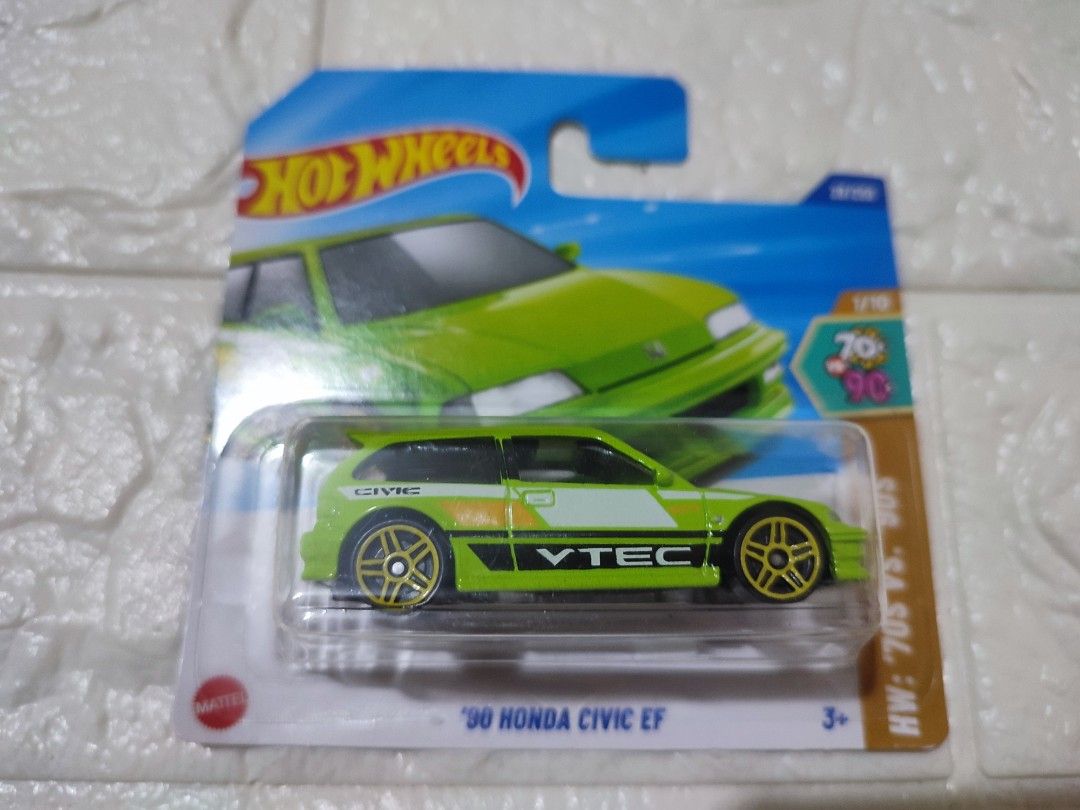 Hot Wheels '90 Honda Civic EF (Category: Vehicle & Diecast Models) located in Narvacan. Submitted by jigger85 (Listing ID 1419531138, Image 1). Description: - Hot Wheels '90 Honda Civic EF diecast car - Vibrant green color - Features VTEC branding - Gold-colored wheels - Still in original packaging - Part of the 70th Anniversary series.