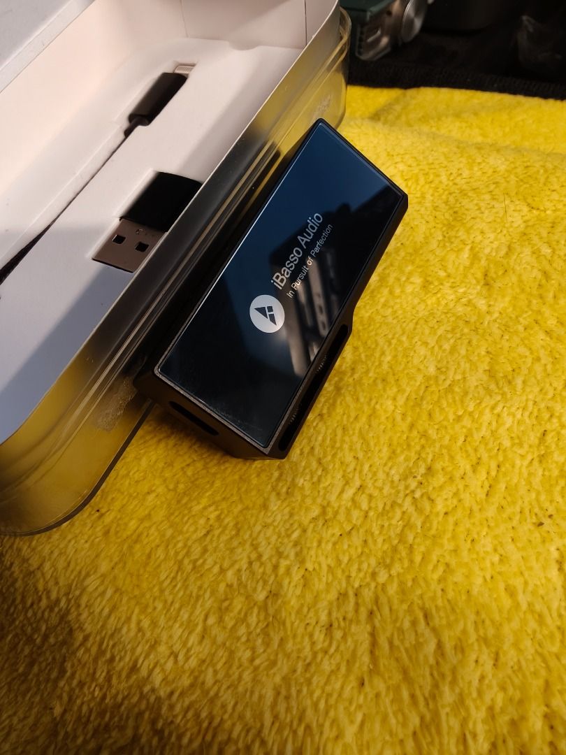 IBASSO DC06 PRO DONGLE DAC (Category: Soundbars, Speakers & Amplifiers) located in Imus. Submitted by gadgetphoenix (Listing ID 1419582580, Image 3). Description: IBASSO DC06 PRO SELLING PRICE: 8,499 PHP Condition & Quality: Condition: Excellent / Near Pristine (99% smooth). Physical State: No dents, cracks, or scratches; meticulously handled. History: Purchased June 13, 2024. Functionality: 100% working; zero issues. The Full Package: Unit: iBas