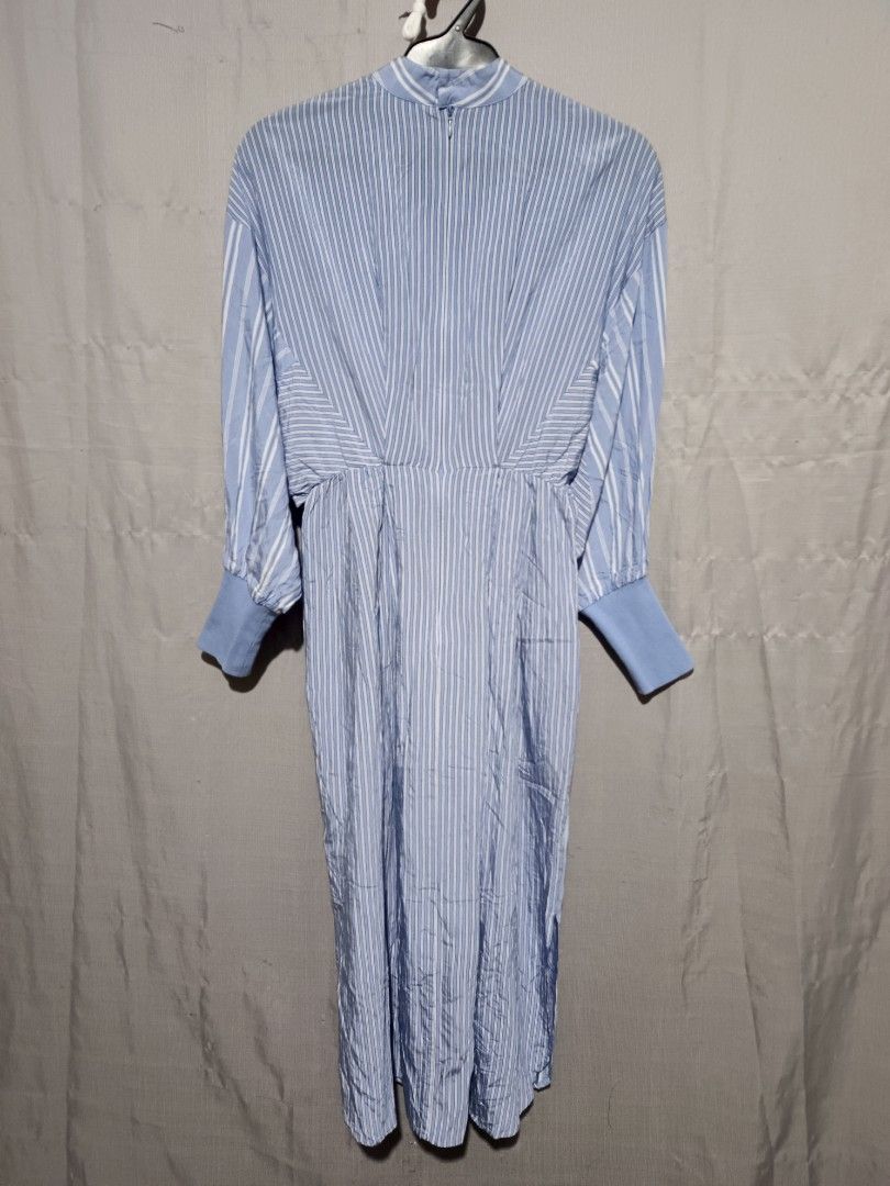Initial Striped Midi Dress (Category: Dresses) located in Dasmarinas. Submitted by jessputrages (Listing ID 1419555983, Image 2). Description: - Initial midi dress - Light blue and white striped pattern - Long sleeves with cuff details - Mock neck - Fitted waist - Flowing skirt - Fabric: Rayon and nylon blend - Care: Professional dry clean only.