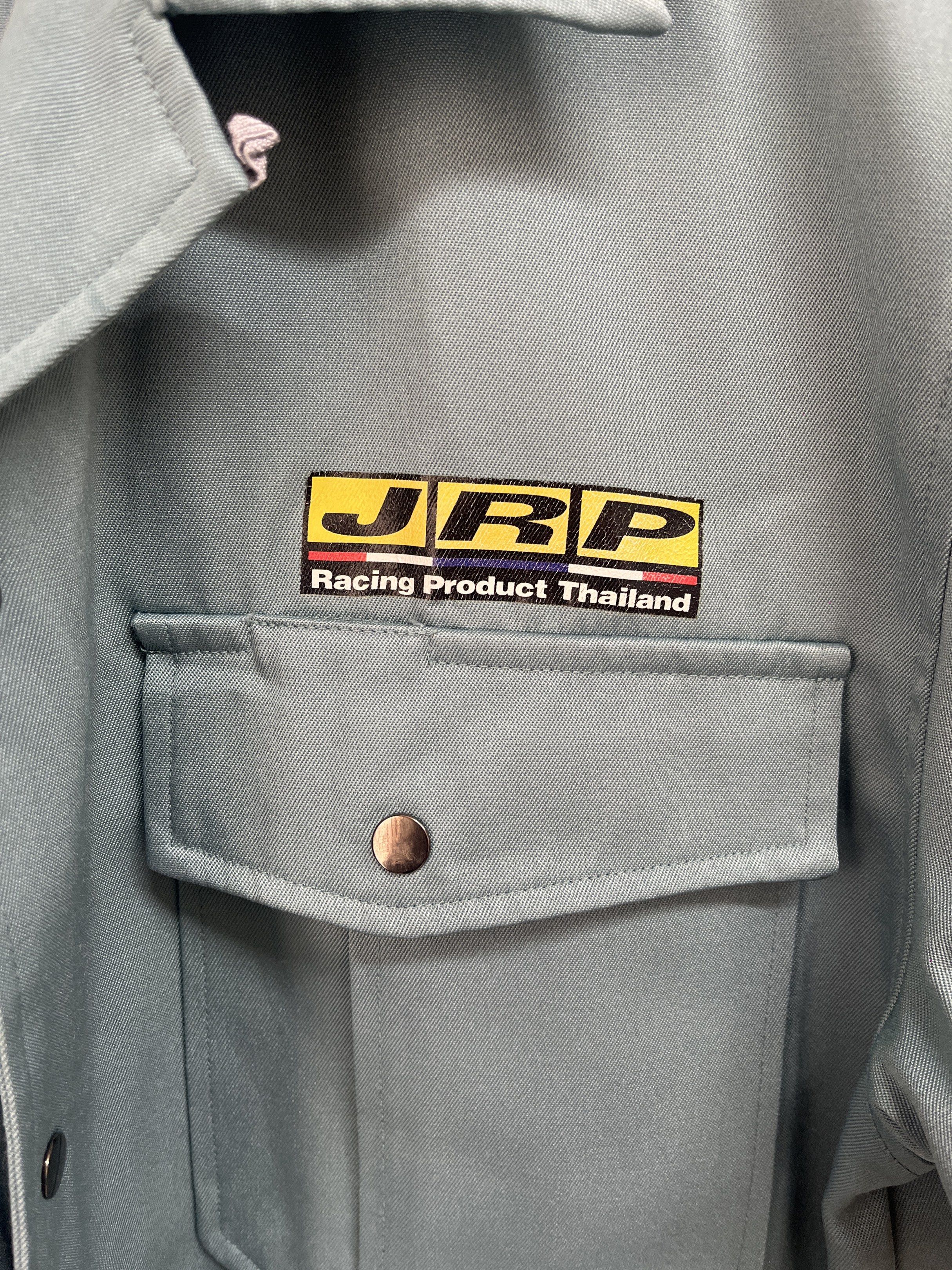 JRP Racing Product Thailand Jacket (Category: Coats, Jackets and Outerwear) located in Muntinlupa City. Submitted by timttam (Listing ID 1419481938, Image 2). Description: - Bluish green jacket - JRP Racing Product Thailand logo - Two chest pockets with button closures - Buttoned cuffs - Pleated back design - Collared neckline - Button-down front.