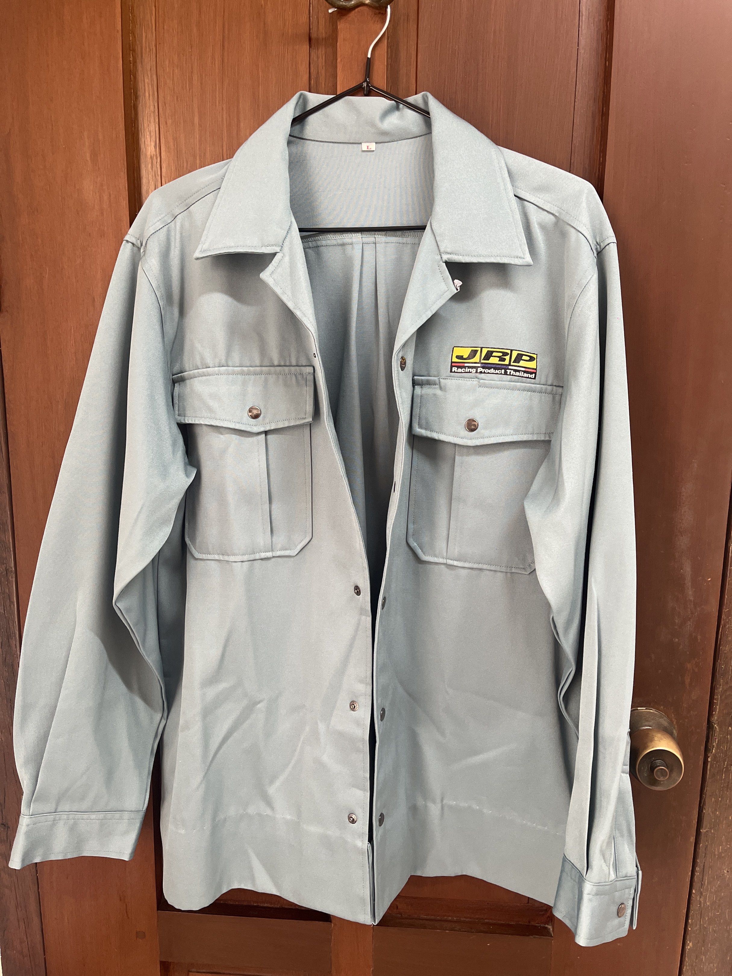 JRP Racing Product Thailand Jacket (Category: Coats, Jackets and Outerwear) located in Muntinlupa City. Submitted by timttam (Listing ID 1419481938, Image 1). Description: - Bluish green jacket - JRP Racing Product Thailand logo - Two chest pockets with button closures - Buttoned cuffs - Pleated back design - Collared neckline - Button-down front.