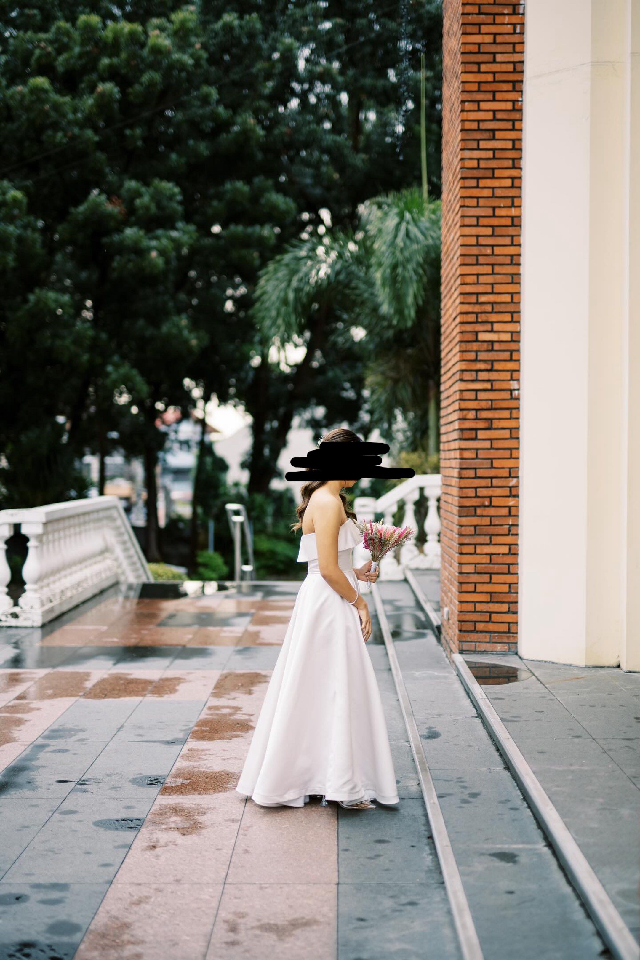 June 12 The Label White Dress (Category: Evening dresses & gowns) located in Quezon City. Submitted by maveeyy (Listing ID 1419504697, Image 2). Description: - Strapless / tube white gown - Fitted bodice - Flowing A-line skirt - Simple, classic design - Duchess satin fabric - Pearl white Cruz dress, custom made by June 12 the Label. Used only once for our small church wedding. Height: 5”3,Bust: 34, Waist: 28 Original price: 8-10k depending on the