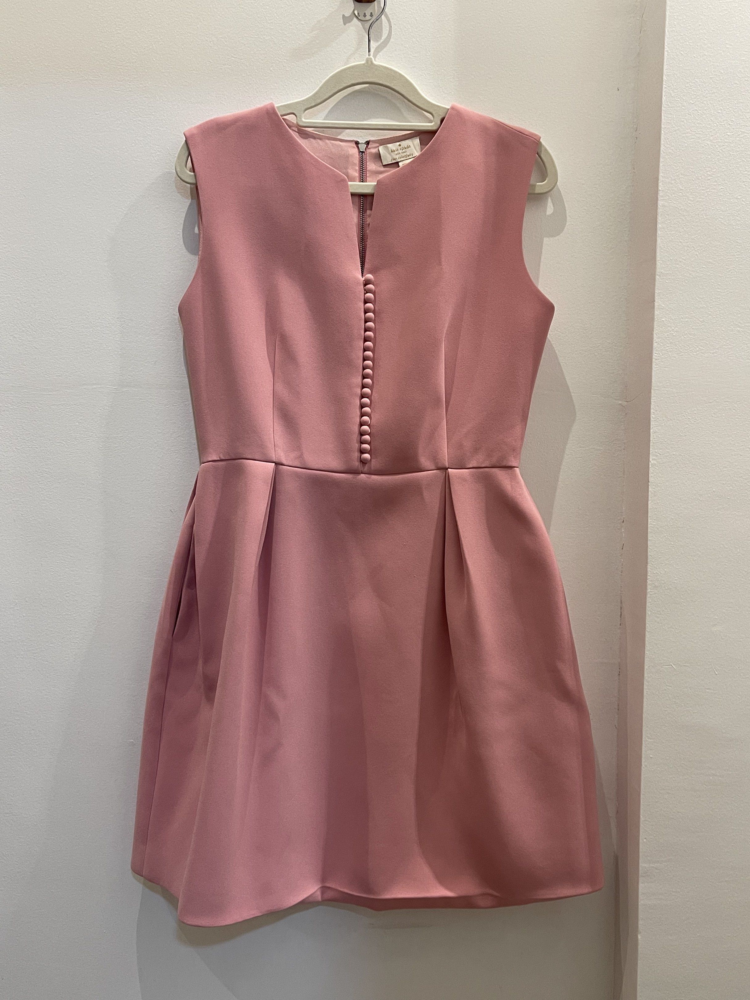 Kate Spade Sleeveless Dress (Category: Dresses) located in Tacloban City. Submitted by declutterwithbel (Listing ID 1419408293, Image 1). Description: - Elegant sleeveless dress from Kate Spade. - Features a flattering A-line silhouette with a fitted bodice and a flared skirt. The dress has a front button detail (decorative only) and a back zipper closure. The dress is a soft pink color. - Runs about 85cm in length, 41 cm chest (laid flat) - Fits