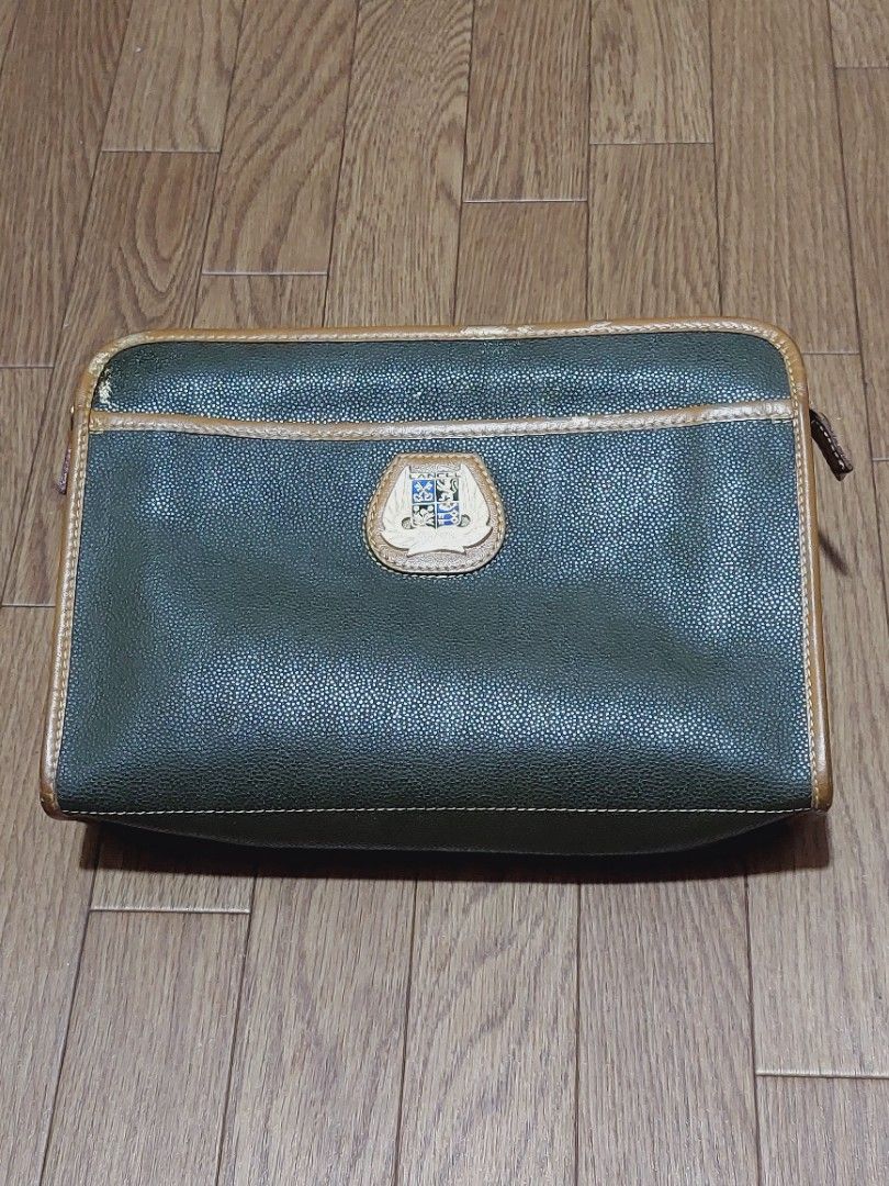 Lancel Clutch Bag (Category: Luxury Bags & Wallets) located in Muntinlupa City. Submitted by sakurambo_des (Listing ID 1419505706, Image 1). Description: - Vintage Lancel Clutch Bag - Unisex design - Green exterior with brown trim - Features Lancel logo - Secure zipper closure - Classic and stylish accessory *flaws-gold paint mark,kindly check pictures..