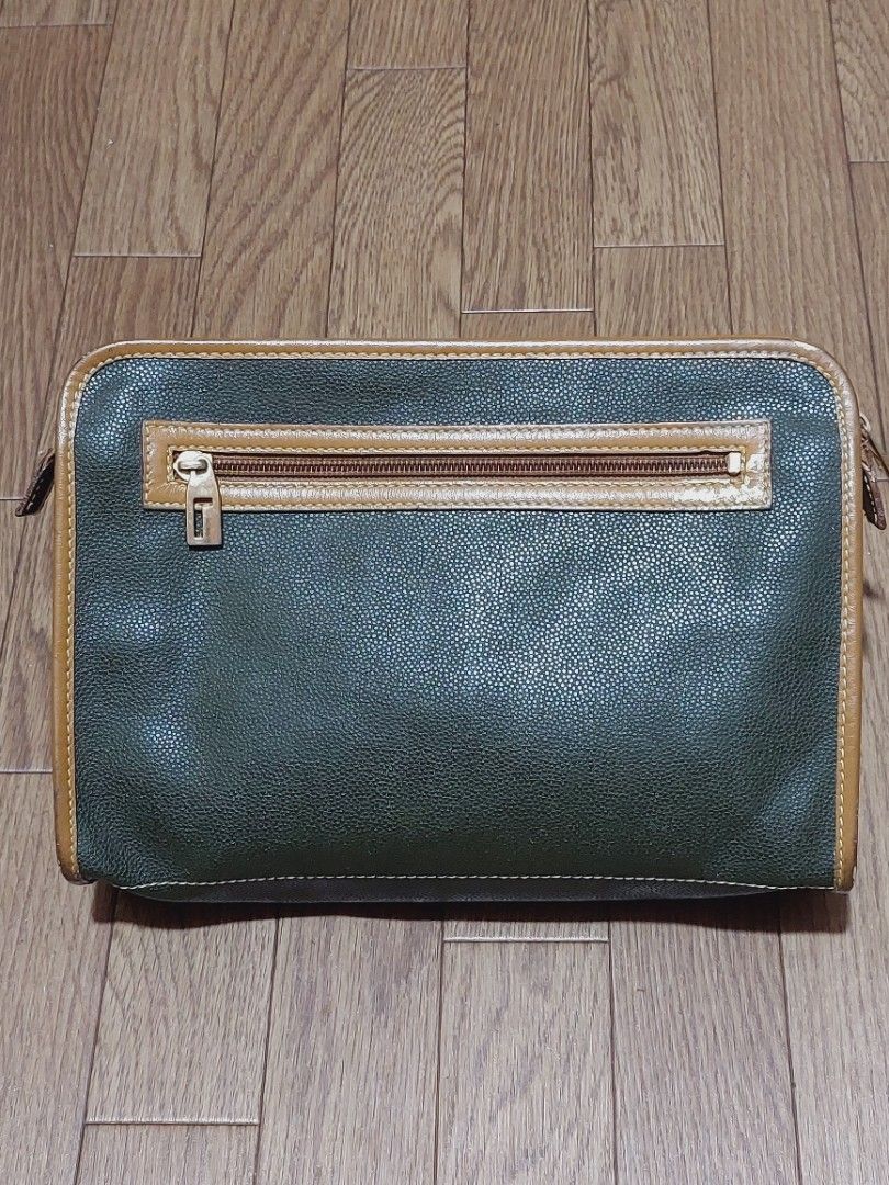 Lancel Clutch Bag (Category: Luxury Bags & Wallets) located in Muntinlupa City. Submitted by sakurambo_des (Listing ID 1419505706, Image 2). Description: - Vintage Lancel Clutch Bag - Unisex design - Green exterior with brown trim - Features Lancel logo - Secure zipper closure - Classic and stylish accessory *flaws-gold paint mark,kindly check pictures..