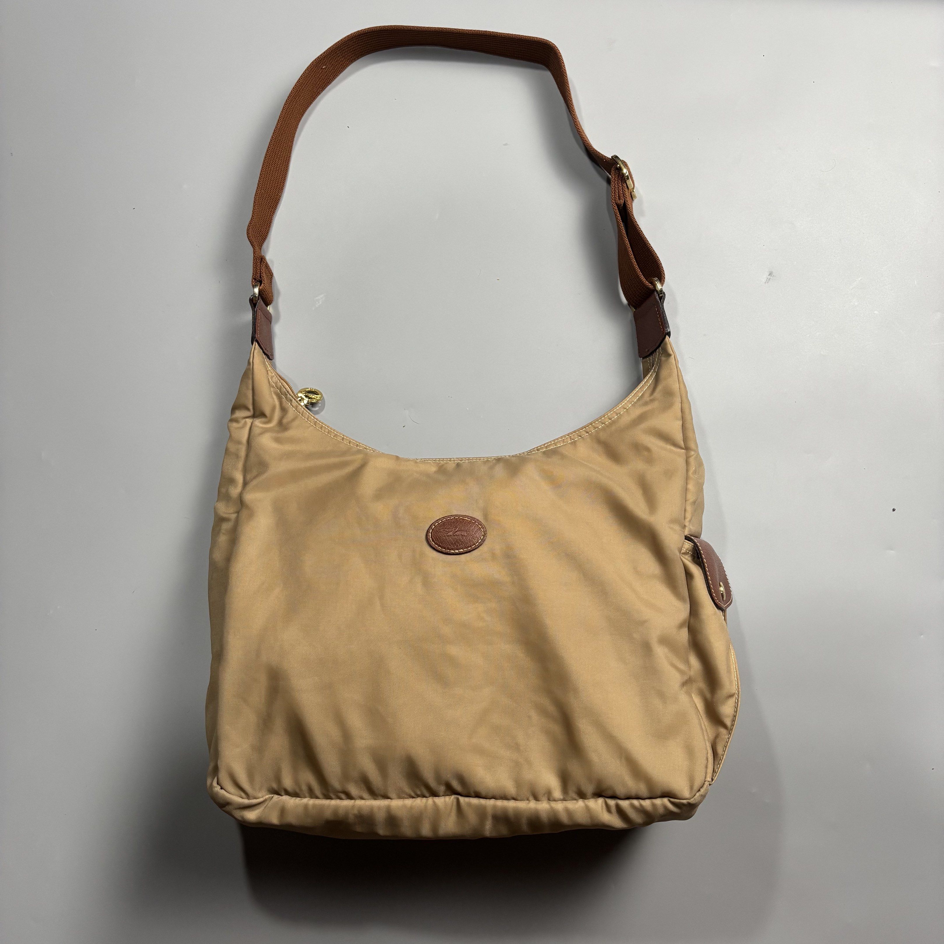Authentic Longchamp Le Pliage Hobo Desert Bag Shoulder Bag (Category: Luxury Bags & Wallets) located in Magalang. Submitted by luxgood18 (Listing ID 1419558544, Image 1). Description: Longchamp Le Pliage Hobo Desert Bag Rank ab Guaranteed authentic ✅✅ The adjustable shoulder strap provides a personalized fit, while the backpack accommodates a 14” laptop and offers multiple storage pockets. The zip and snap closures, along with the sustainable Eco