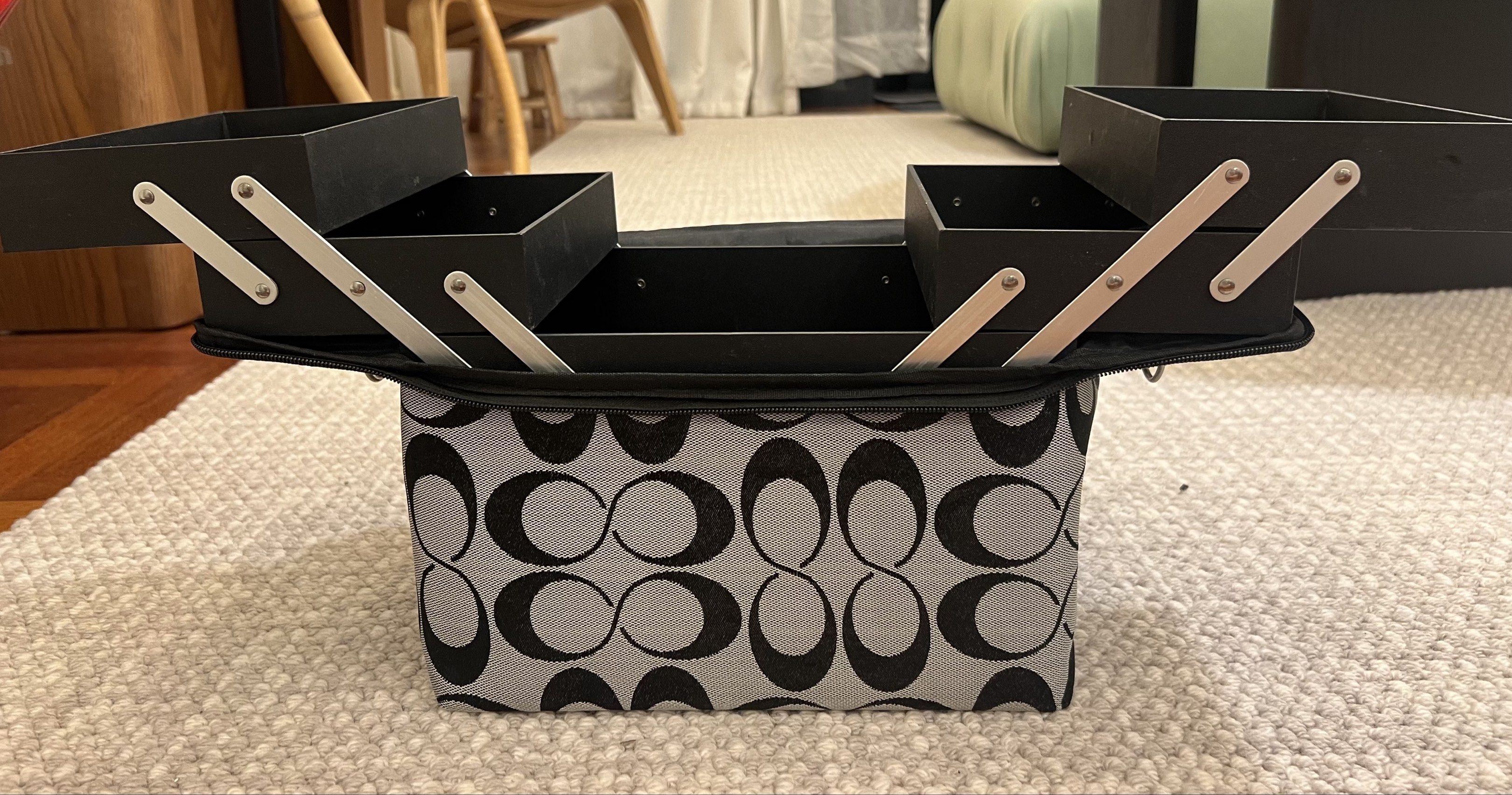 Makeup Case with Multiple Compartments (Category: Purses & Pouches) located in Kuala Lumpur. Submitted by crystal88lai (Listing ID 1419564673, Image 2). Description: - Stylish makeup case - Black and grey pattern - Multiple compartments and trays for organization - Includes zippered pouch with brush pockets - Convenient handle for carrying - Secure zip closure.