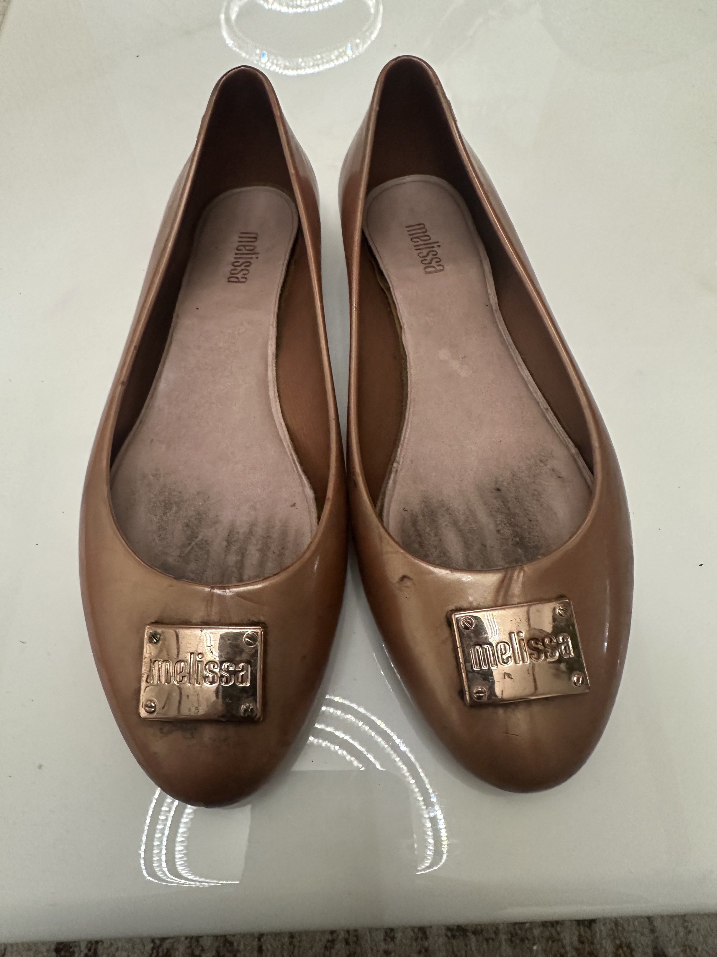 Melissa Flats - Bronze (Category: Flats & Sandals) located in Antipolo. Submitted by capizexport (Listing ID 1419524516, Image 2). Description: Bronze Melissa flats, size 15/36 (22cm). Made in Brazil. Features metallic logo. Can be cleaned and it will be much better in appearance. Price 500 pesos .