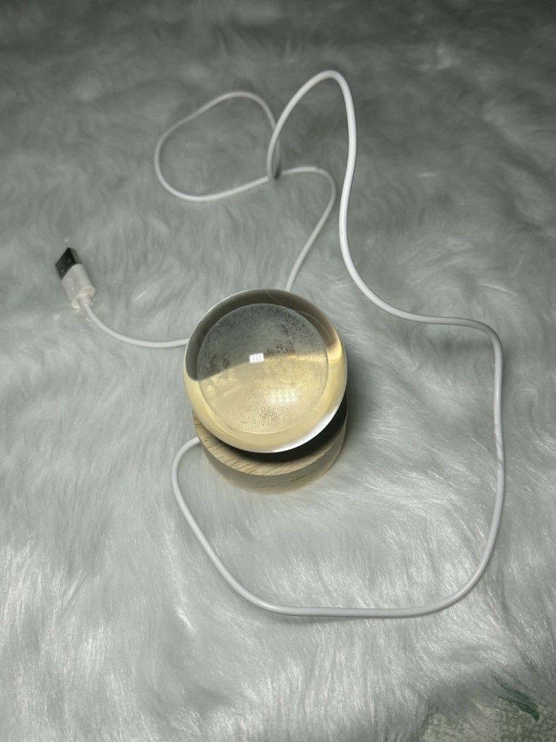 Moon Crystal Ball Night Light Side-table Night Light Moon Lamp (Category: Lighting) located in Manila. Submitted by abcdcv (Listing ID 1419435495, Image 3). Description: - Crystal ball night light with moon design - Features a wooden base - Powered via USB cable - Emits a warm, yellow light - Brand new, in original packaging.
