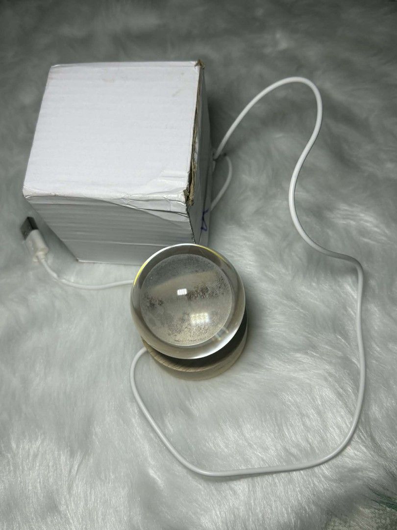 Moon Crystal Ball Night Light Side-table Night Light Moon Lamp (Category: Lighting) located in Manila. Submitted by abcdcv (Listing ID 1419435495, Image 2). Description: - Crystal ball night light with moon design - Features a wooden base - Powered via USB cable - Emits a warm, yellow light - Brand new, in original packaging.