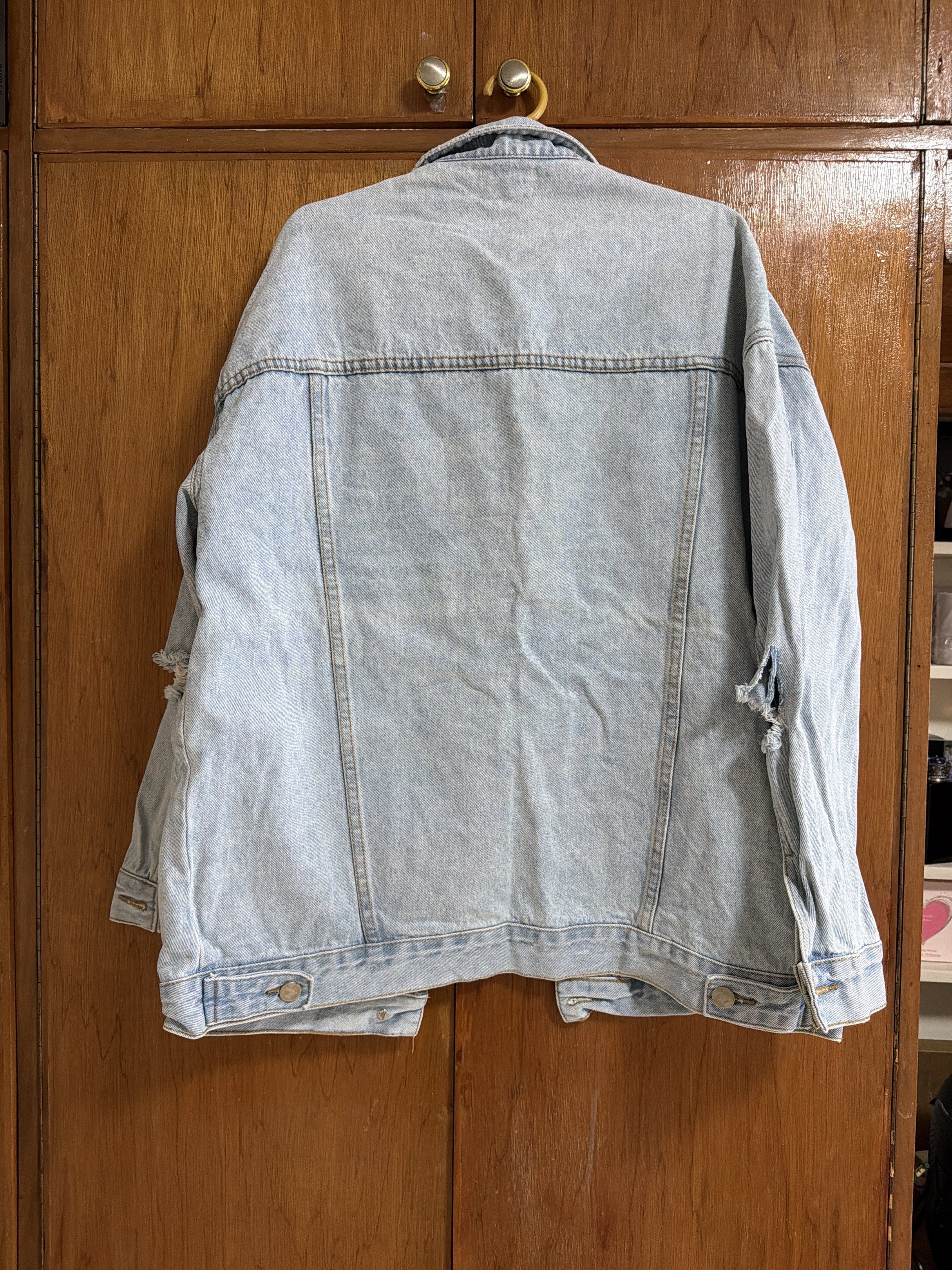 Oversized Denim Jacket (Category: Coats, Jackets and Outerwear) located in Manila. Submitted by dmdnice (Listing ID 1419440340, Image 3). Description: - DDY Designer Brands denim jacket - Light blue color - Distressed design with ripped details - Two chest pockets - Button closures - Classic collar - Relaxed fit - Perfect for layering.
